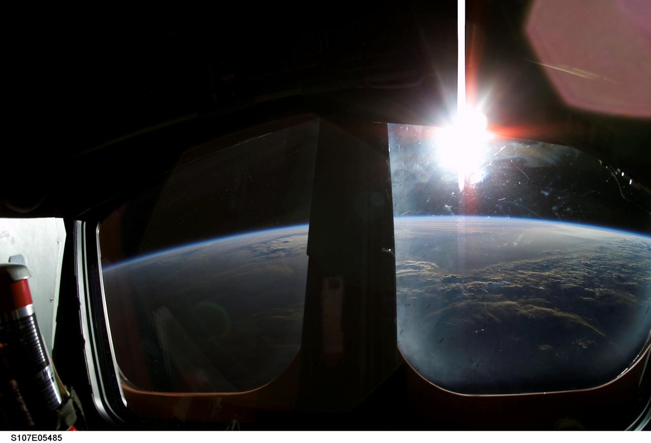 This sunrise was captured from the crew cabin of the Space Shuttle Orbiter Columbia on the STS-107 mission. Launched January 16, 2003, STS-107 was strictly a multidiscipline microgravity and Earth science research mission involving 80-plus International experiments performed during 16-days, many of which were managed by the Marshall Space Flight Center in Huntsville, Alabama. The majority of the research was conducted in the Shuttle's mid deck, the area directly under the cockpit, in the new SPACEHAB Research Double Module. This was the first flight for that module, which doubled the volume available for experiments and significantly increased the amount and complexity of research from the last dedicated Shuttle science mission, STS-95, flown in 1998 with a single SPACEHAB module. The pressurized module was carried in Columbia's payload bay and was accessible to the crew via a turnel from the Shuttle's mid deck.
