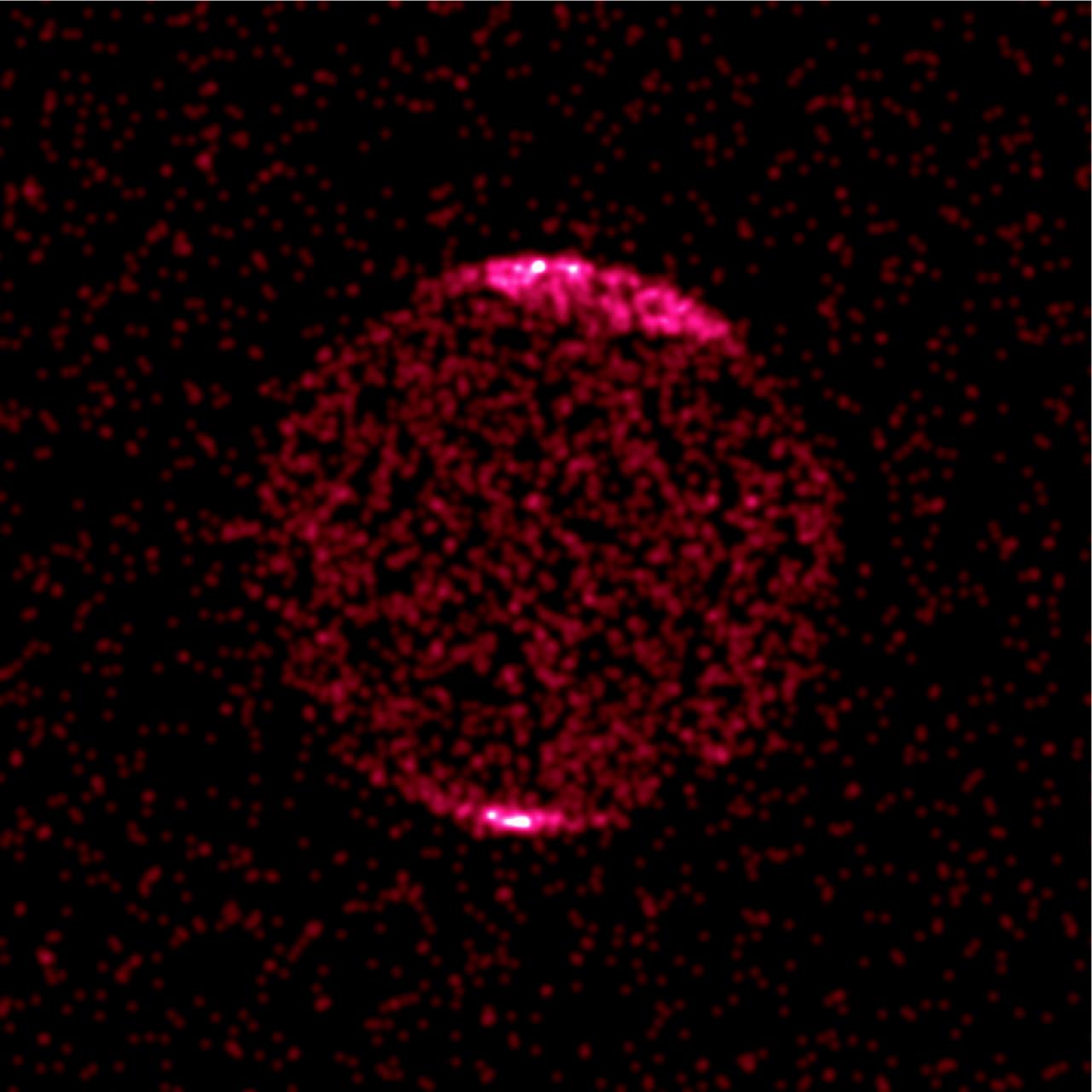 This Chandra image of Jupiter shows concentrations of aurora x-rays near the north and south poles due to a single `hot spot' that pulsates with a period of 45 minutes, similar to high-latitude radio pulsation previously detected by NASA's Galileo and Cassini spacecraft. Previous x-ray detections of Jupiter have been made with other x-ray telescopes, but did not reveal that the sources of the x-rays, energetic oxygen and sulfur ions, would be located so near the poles. Previous theories held that ions were mostly coming from Jupiter's moon, lo. Chandra's ability to pinpoint the source of the x-rays discards this theory since ions coming from near lo's orbit carnot reach the observed high latitudes. One possibility is that particles flowing out from the Sun are captured in the outer regions of Jupiter's magnetic field, then accelerated and directed toward its magnetic pole. Once captured, the ions would bounce back and forth in the magnetic field from Jupiter's north pole to the south pole in an oscillating motion that could explain the pulsation.