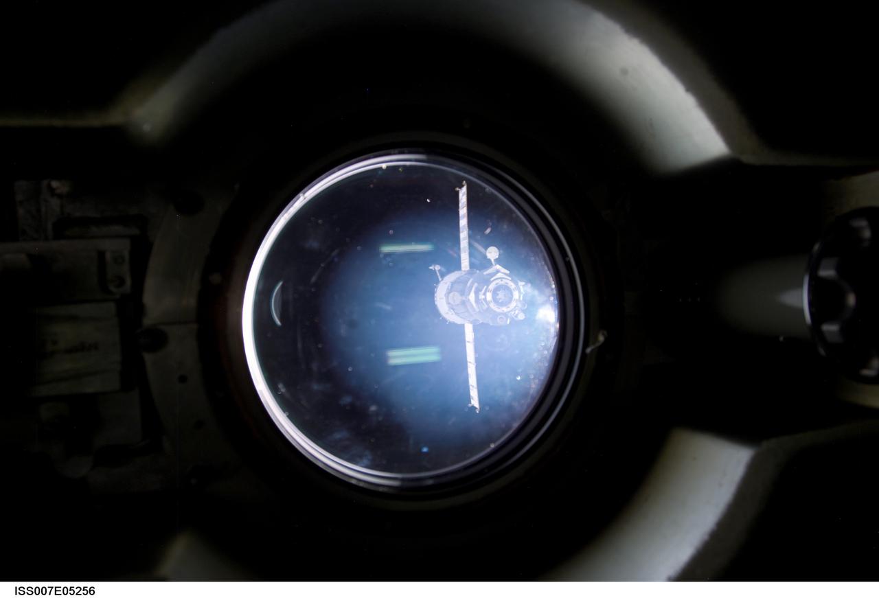 Expedition Seven photographed the Soyez TMA-1 Capsule through a window of the International Space Station (ISS) as it departed for Earth. Aboard were Expedition Six crew members, astronauts Kerneth D. Bowersox and Donald R. Pettit, and cosmonaut Nikolai M. Budarin. Expedition Six served a 5 and 1/2 month stay aboard the ISS, the longest stay to date.