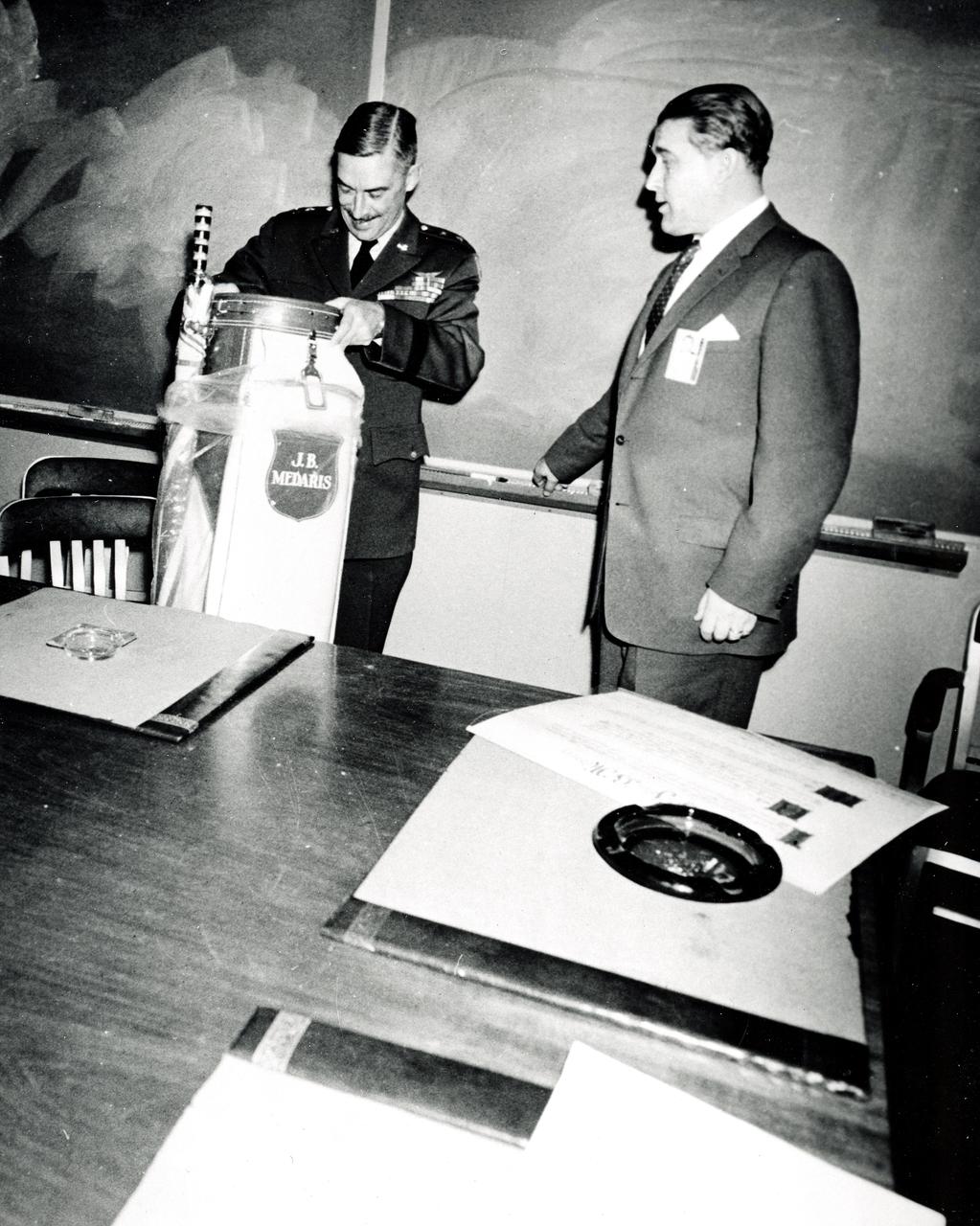 Marshall Space Flight Center Director Wernher von Braun presents General J.B. Medaris with a new golf bag. General Medaris, (left) was a Commander of the Army Ballistic Missile Agency (ABMA) in Redstone Arsenal, Alabama during 1955 to 1958.