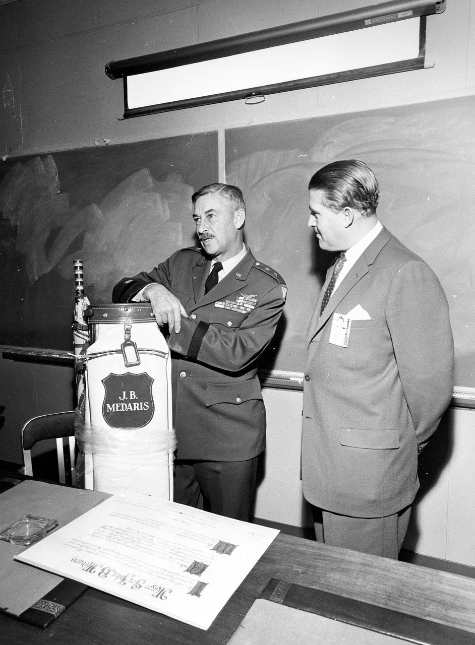 Marshall Space Flight Center Director Wernher von Braun presents General J.B. Medaris with a new golf bag. General Medaris, (left) was a Commander of the Army Ballistic Missile Agency (ABMA) in Redstone Arsenal, Alabama during 1955 to 1958.