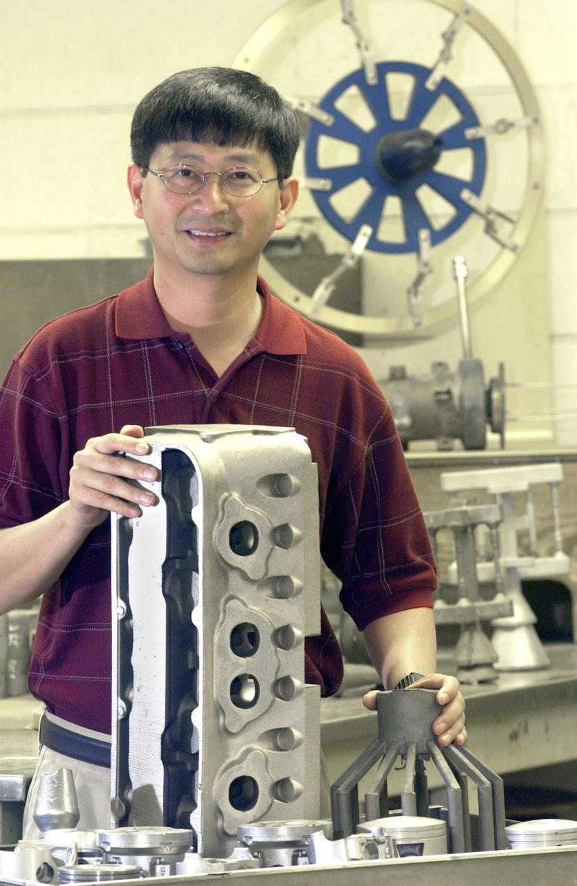 NASA structural materials engineer, Jonathan Lee, displays blocks and pistons as examples of some of the uses for NASA’s patented high-strength aluminum alloy originally developed at Marshall Space Flight Center in Huntsville, Alabama. NASA desired an alloy for aerospace applications with higher strength and wear-resistance at elevated temperatures.  The alloy is a solution to reduce costs of aluminum engine pistons and lower engine emissions for the automobile industry. The Boats and Outboard Engines Division at Bombardier Recreational Products of Sturtevant, Wisconsin is using the alloy for pistons in its Evinrude E-Tec outboard engine line.