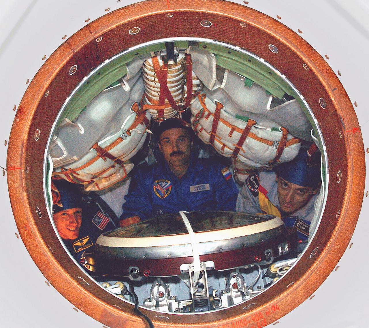 Posed inside the Soyuz TMA-3 Vehicle in a processing facility at the Baikonur Cosmodrome in Kazakhstan during a pre-launch inspection are (left to right): Expedition-8 Crew members, Michael C. Foale, Mission Commander and NASA ISS Science Officer; Cosmonaut Alexander Y. Kaleri, Soyuz Commander and flight engineer; and European Space Agency (ESA) astronaut Pedro Duque of Spain. The three launched from the Cosmodrome on October 18, 2003 onboard a Soyuz rocket destined for the International Space Station (ISS).