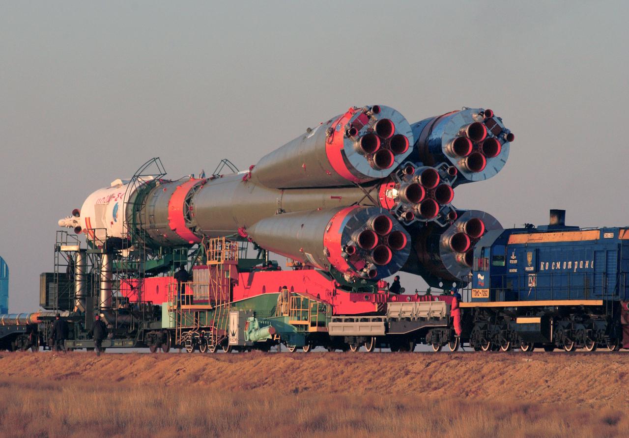 The Soyuz TMA-3 spacecraft and its booster rocket (rear view) is shown on a rail car for transport to the launch pad where it was raised to a vertical launch position at the Baikonur Cosmodrome, Kazakhstan on October 16, 2003. Liftoff occurred on October 18th, transporting a three man crew to the International Space Station (ISS). Aboard were Michael Foale, Expedition-8 Commander and NASA science officer; Alexander Kaleri, Soyuz Commander and flight engineer, both members of the Expedition-8 crew; and European Space agency (ESA) Astronaut Pedro Duque of Spain. Photo Credit: "NASA/Bill Ingalls"