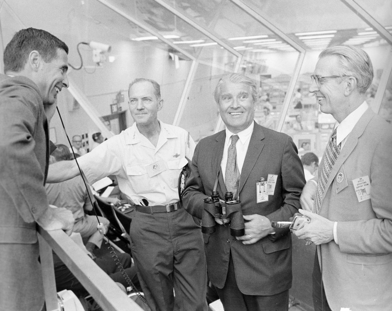 During the Apollo 15 pre-launch activity in the launch control center's firing room 1 at Kennedy Space Center, the then recently appointed NASA Administrator, Dr. James C. Fletcher (right) speaks with (Left to right) William Anders, executive secretary of the National Aeronautics and Space Council; Lt. General Sam Phillips, former Apollo Program Director; and Dr. Wernher von Braun, NASA's Deputy Associate Administrator for planning.