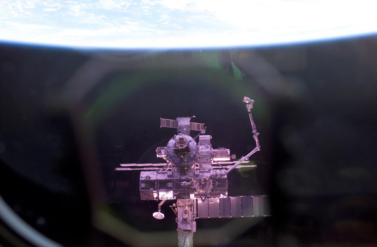 This view of the International Space Station (ISS) was photographed by an STS-112 crew member aboard the Space Shuttle Atlantis during rendezvous and docking operations. Launched October 7, 2002 aboard the Space Shuttle Orbiter Atlantis, the STS-112 mission lasted 11 days and performed three sessions of Extra Vehicular Activity (EVA). Its primary mission was to install the Starboard (S1) Integrated Truss Structure and Equipment Translation Aid (CETA) Cart to the ISS. The S1 truss provides structural support for the orbiting research facility's radiator panels, which use ammonia to cool the Station's complex power system. The S1 truss, attached to the S0 (S Zero) truss, installed by the previous STS-110 mission, flows 637 pounds of anhydrous ammonia through three heat rejection radiators. The truss is 45-feet long, 15-feet wide, 10-feet tall, and weighs approximately 32,000 pounds. The CETA is the first of two human-powered carts that will ride along the railway on the ISS providing a mobile work platform for future extravehicular activities by astronauts.