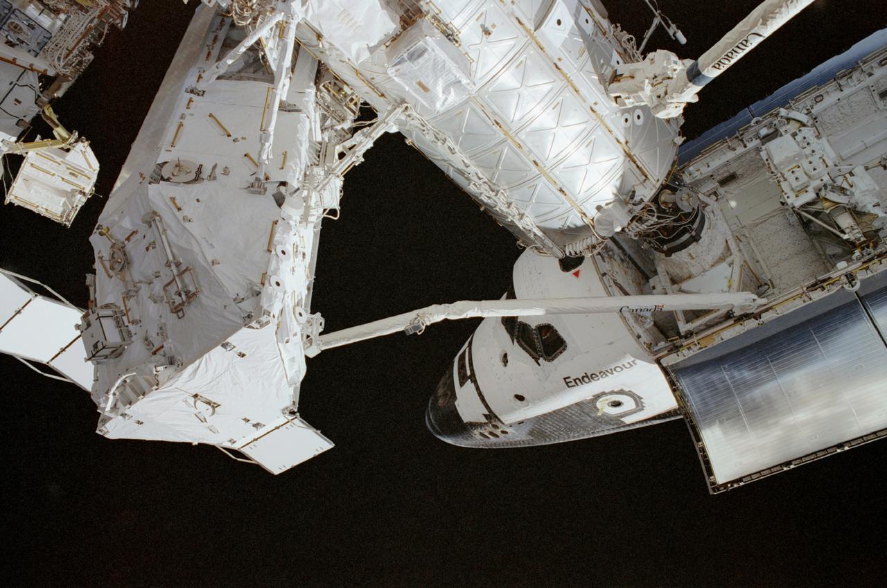 The STS-111 mission, the 14th Shuttle mission to visit the International Space Station (ISS), was launched on June 5, 2002 aboard the Space Shuttle Orbiter Endeavour. On board were the STS-111 and Expedition Five crew members. Astronauts Kerneth D. Cockrell, commander; Paul S. Lockhart, pilot, and mission specialists Franklin R. Chang-Diaz and Philippe Perrin were the STS-111 crew members. Expedition Five crew members included Cosmonaut Valeri G. Korzun, commander, Astronaut Peggy A. Whitson and Cosmonaut Sergei Y. Treschev, flight engineers. Three space walks enabled the STS-111 crew to accomplish mission objectives: The delivery and installation of the Mobile Remote Servicer Base System (MBS), an important part of the Station's Mobile Servicing System that allows the robotic arm to travel the length of the Station, which is necessary for future construction tasks; the replacement of a wrist roll joint on the Station's robotic arm; and the task of unloading supplies and science experiments from the Leonardo multipurpose Logistics Module, which made its third trip to the orbital outpost. In this photograph, the Space Shuttle Endeavour, back dropped by the blackness of space, is docked to the pressurized Mating Adapter (PMA-2) at the forward end of the Destiny Laboratory on the ISS. Endeavour's robotic arm is in full view as it is stretched out with the S0 (S-zero) Truss at its end.