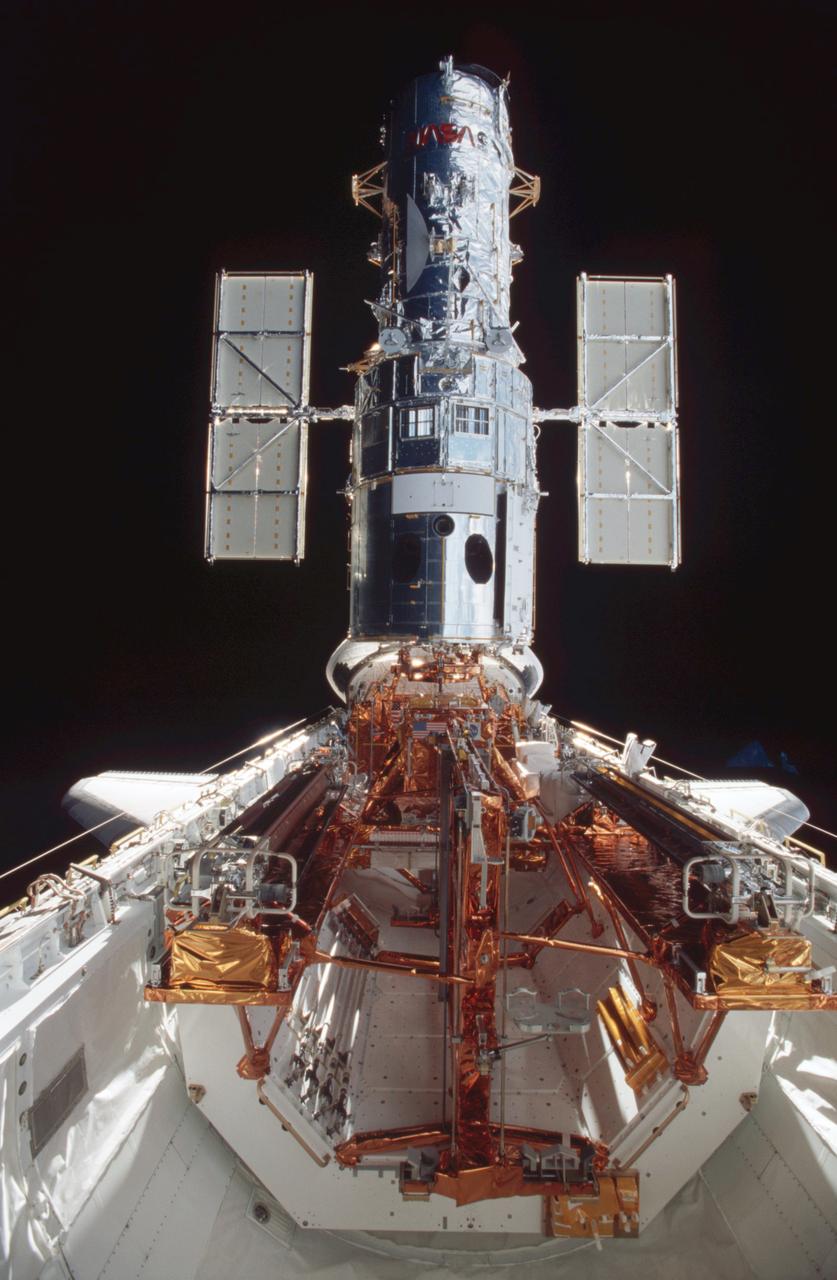 After five days of service and upgrade work on the Hubble Space Telescope (HST), the STS-109 crew photographed the giant telescope in the shuttle's cargo bay. The telescope was captured and secured on a work stand in Columbia's payload bay using Columbia's robotic arm, where 4 of the 7-member crew performed 5 space walks completing system upgrades to the HST. Included in those upgrades were: The replacement of the solar array panels; replacement of the power control unit (PCU); replacement of the Faint Object Camera (FOC) with a new advanced camera for Surveys (ACS); and installation of the experimental cooling system for the Hubble's Near-Infrared Camera and Multi-object Spectrometer (NICMOS), which had been dormant since January 1999 when its original coolant ran out. The Marshall Space Flight Center had the responsibility for the design, development, and construction of the the HST, which is the most complex and sensitive optical telescope ever made, to study the cosmos from a low-Earth orbit. Launched March 1, 2002, the STS-109 HST servicing mission lasted 10 days, 22 hours, and 11 minutes. It was the 108th flight overall in NASA's Space Shuttle Program.