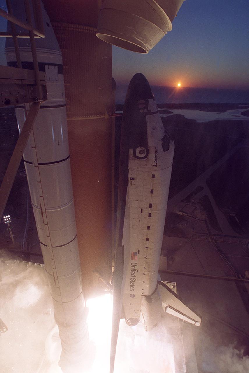 The Space Shuttle Discovery, STS-102 mission, clears launch pad 39B at the Kennedy Space Center as the sun peers over the Atlantic Ocean on March 8, 2001. STS-102's primary cargo was the Leonardo, the Italian Space Agency built Multipurpose Logistics Module (MPLM). The Leonardo MPLM is the first of three such pressurized modules that will serve as the International Space Station's (ISS') moving vans, carrying laboratory racks filled with equipment, experiments, and supplies to and from the Station aboard the Space Shuttle. The cylindrical module is approximately 21-feet long and 15- feet in diameter, weighing almost 4.5 tons. It can carry up to 10 tons of cargo in 16 standard Space Station equipment racks. Of the 16 racks the module can carry, 5 can be furnished with power, data, and fluid to support refrigerators or freezers. In order to function as an attached station module as well as a cargo transport, the logistics module also includes components that provide life support, fire detection and suppression, electrical distribution, and computer functions. NASA's 103rd overall flight and the eighth assembly flight, STS-102 was also the first flight involved with Expedition Crew rotation. The Expedition Two crew was delivered to the station while Expedition One was returned home to Earth.
