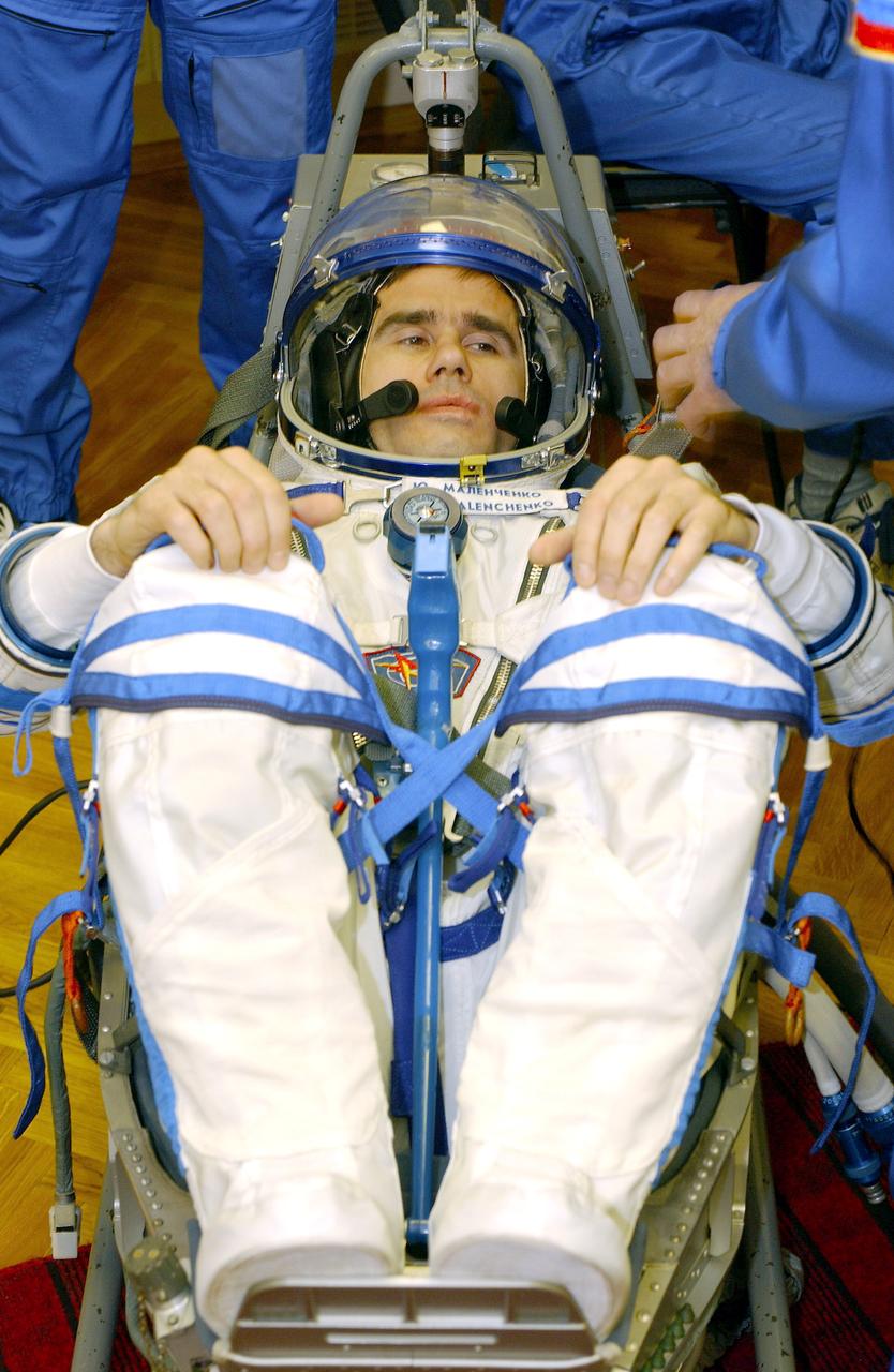 April 10, 2003.  Baikonur Cosmodrome, Kazakhstan. Building 254, Soyuz Integration Facility.  Cosmonaut Yuri I. Malenchenko, Expedition Seven commander dons his Russian Sokol suit for the leak check and Soyuz inspection, seat liner check. Photo Credit: "NASA/Bill Ingalls"