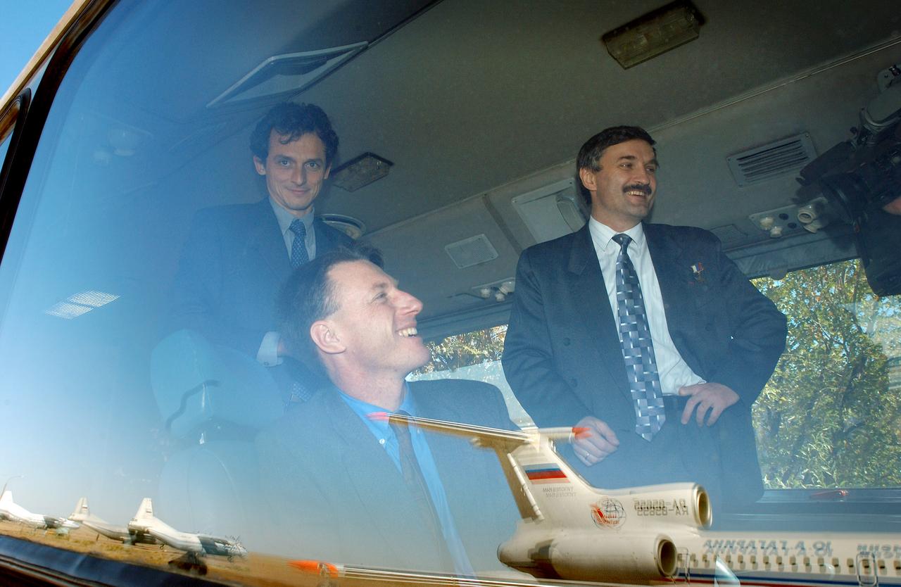 October 12, 2003, Baikonur, Kazakhstan. (left to right) European Space Agency Astronaut Pedro Duque of Spain, Expedition 8 Commander Michael Foale, Expedition 8 Soyuz Commander and Flight Engineer Alexander Kaleri gather on the bus after the flight down from Moscow to Baikonur, Kazakhstan. Expedition 8 is scheduled to launch from the Baikonur Cosmodrome in Kazakhstan on October 18th onboard a Soyuz rocket to the International Space Station. Photo Credit: "NASA/Bill Ingalls"