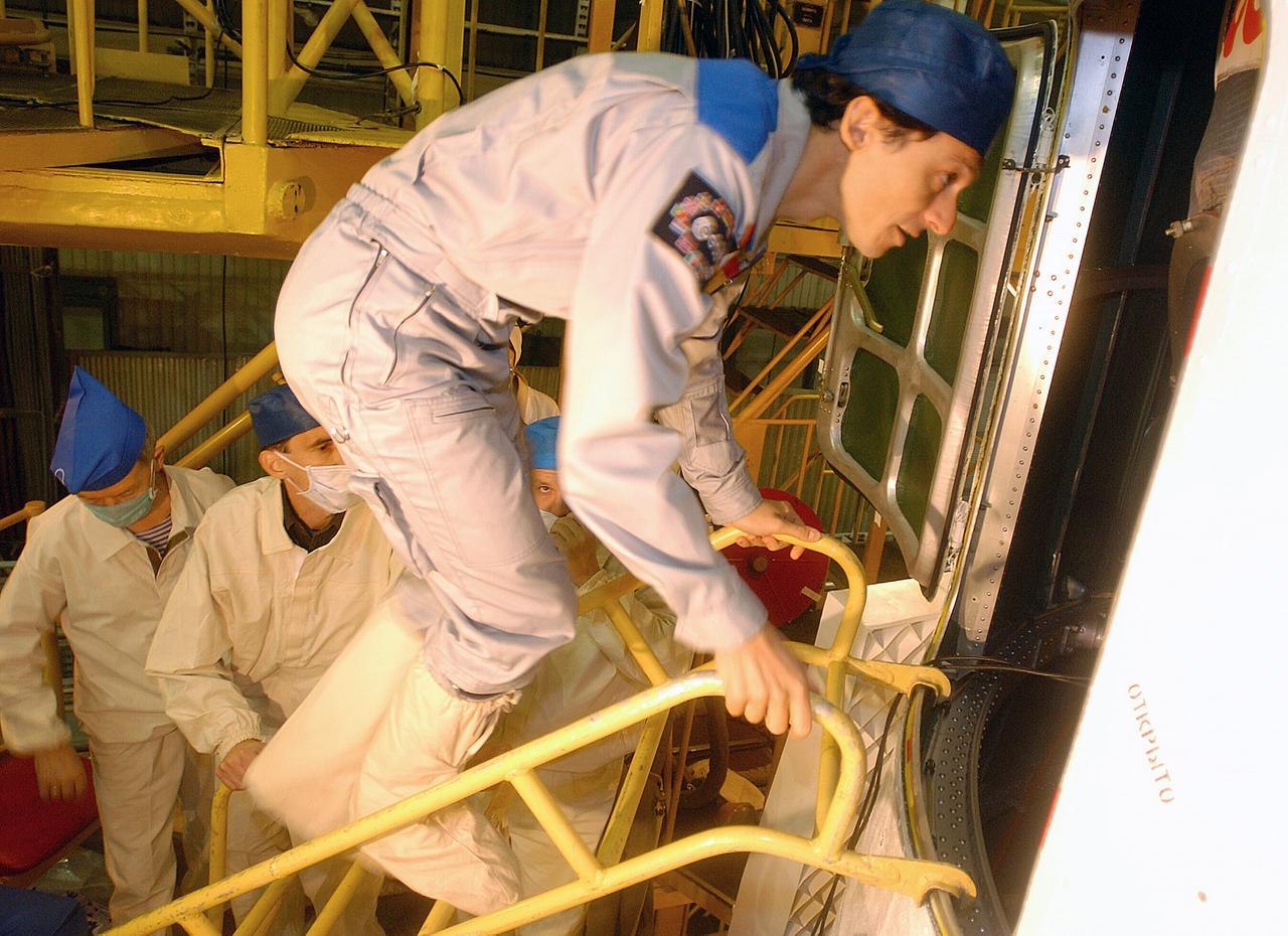 October 13, 2003.  Baikonur Cosmodrome, Kazakhstan. European Space Agency Astronaut Pedro Duque of Spain climbs into the Soyuz TMA-3 vehicle in a processing facility at the Baikonur Cosmodrome in Kazakhstan on Oct. 13, 2003 during prelaunch training with his crew mates, Expedition 8 Commander and NASA Science Officer Mike Foale and Expedition 8 soyuz Commander Alexander Kaleri. The trio will be launched on Oct. 18 to the International Space Station.  Photo Credit"NASA/Bill Ingalls"