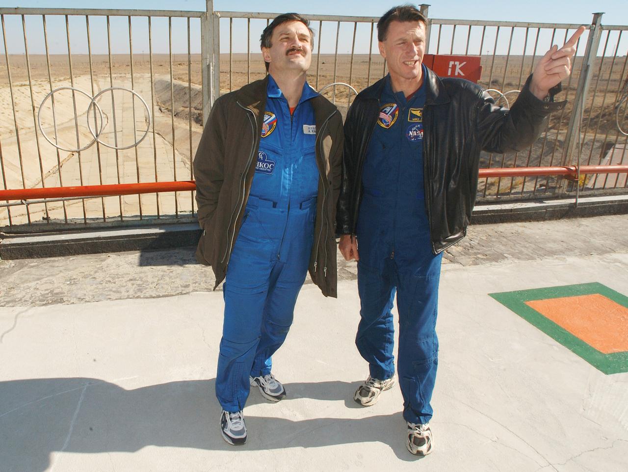 October 13, 2003.  Baikonur Cosmodrome, Kazakhstan. Expedition 8 Soyuz Commander Alexander Kaleri (left) and Expedition 8 Commander and NASA Science Officer Mike Foale visit the launch pad at the Baikonur Cosmodrome in Kazakhstan Oct. 13, 2003. Foale, Kaleri and European Space Agency Astronaut Pedro Duque of Spain will be launched from the Central Asian launch pad to the International Space Station on Oct. 18.  Photo Credit"NASA/Bill Ingalls"