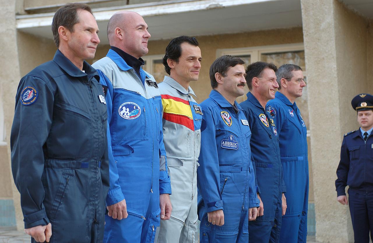October 14, 2003. Cosmonaut Hotel, Baikonur, Kazakhstan. The prime and backup crews for this Saturday's launch of a Soyuz TMA-3 vehicle to the International Space Station participate in the traditional flag-raising ceremony outside the Cosmonaut Hotel Oct. 14, 2003. From left to right are backup Expedition 8 Soyuz Commander Valery Tokarev, backup European Space Agency Astronaut Andre Kuipers of the Netherlands, prime European Space Agency Astronaut Pedro Duque of Spain, prime Expedition 8 Soyuz Commander Alexander Kaleri, prime Expedition 8 Commander and NASA Science Officer Mike Foale and backup Expedition 8 Commander and NASA Science Officer Bill McArthur. Photo Credit: "NASA/Bill Ingalls"