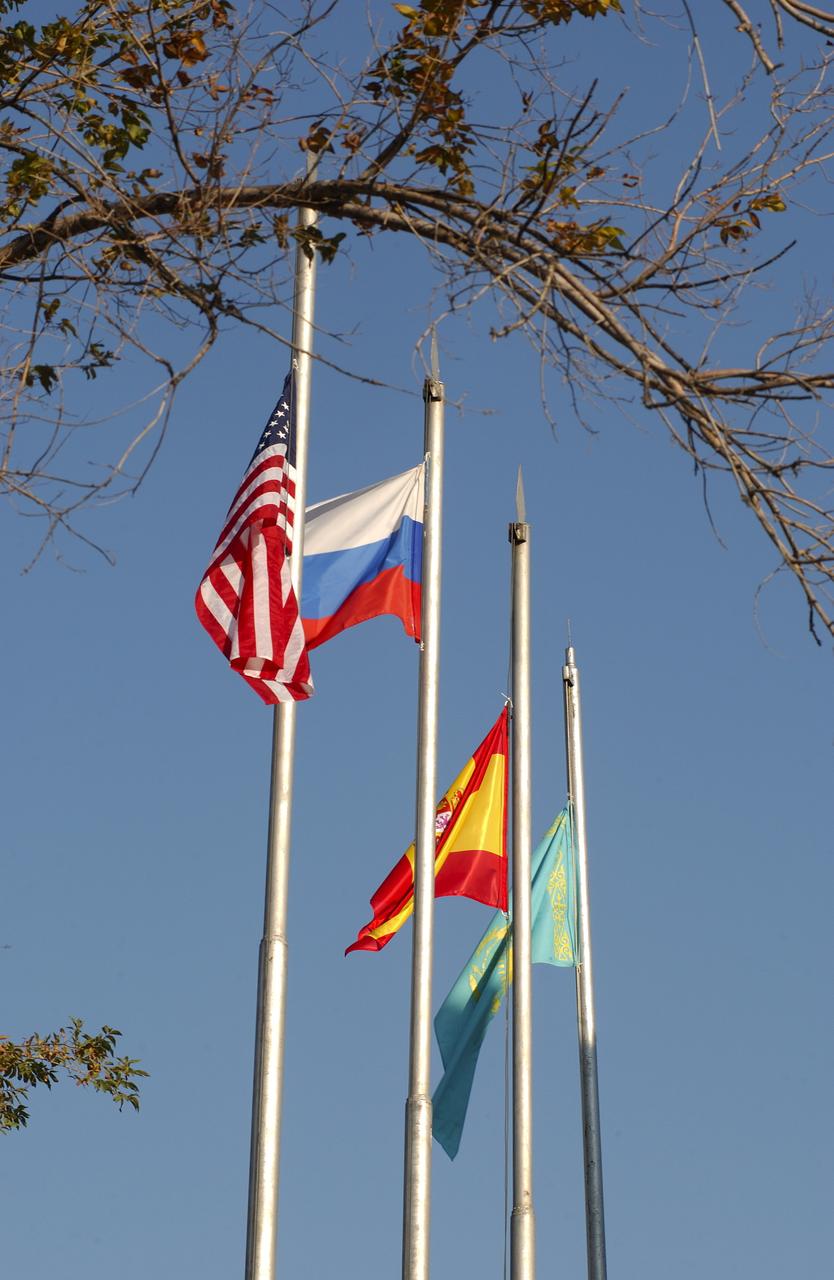 October 14, 2003.  Cosmonaut Hotel, Baikonur, Kazakhstan. The flags of the United States, Russia, Spain and Kazakhstan fly outside the Cosmonaut Hotel Oct. 14, 2003 after they were raised by astronauts and cosmonauts in a traditional prelaunch ritual prior to the launch Saturday of the Soyuz TMA-3 vehicle to the International Space Station. The Soyuz will carry Expedition 8 Commander and NASA Science Officer Mike Foale, Expedition 8 Soyuz Commander Alexander Kaleri and European Space Agency Astronaut Pedro Duque of Spain to the ISS. Photo Credit: "NASA/Bill Ingalls"