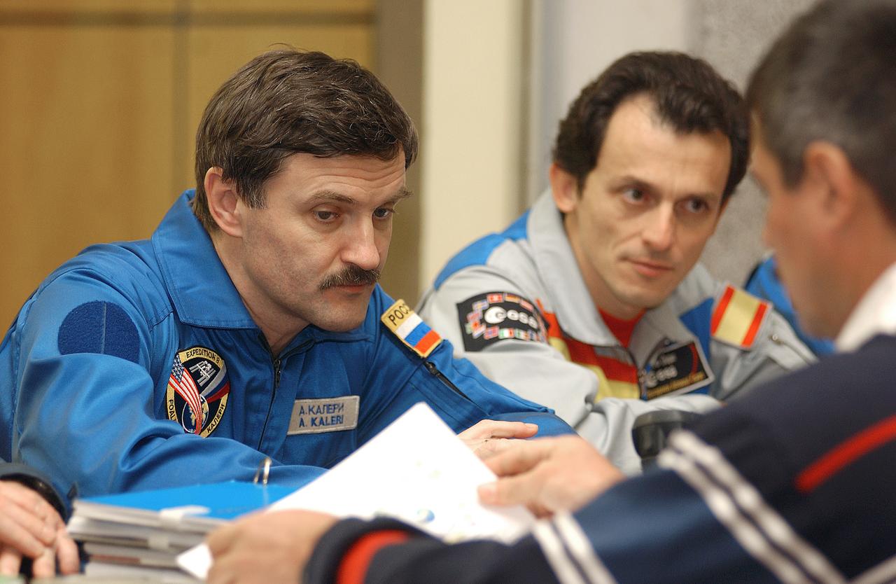 October 15, 2003. Cosmonaut Hotel, Baikonur, Kazakhstan. Expedition 8 Soyuz Commander and Flight Engineer Alexander Kaleri and European Space Agency Astronaut Pedro Duque of Spain receive a briefing on launch procedures from a Russian trainer at their crew quarters in Baikonur, Kazakhstan Oct. 15, 2003 as they prepare for launch Oct. 18 in a Soyuz TMA-3 vehicle to the International Space Station. The mission is led by Expedition 8 Commander Mike Foale (not pictured). Photo Credit: "NASA/Bill Ingalls"