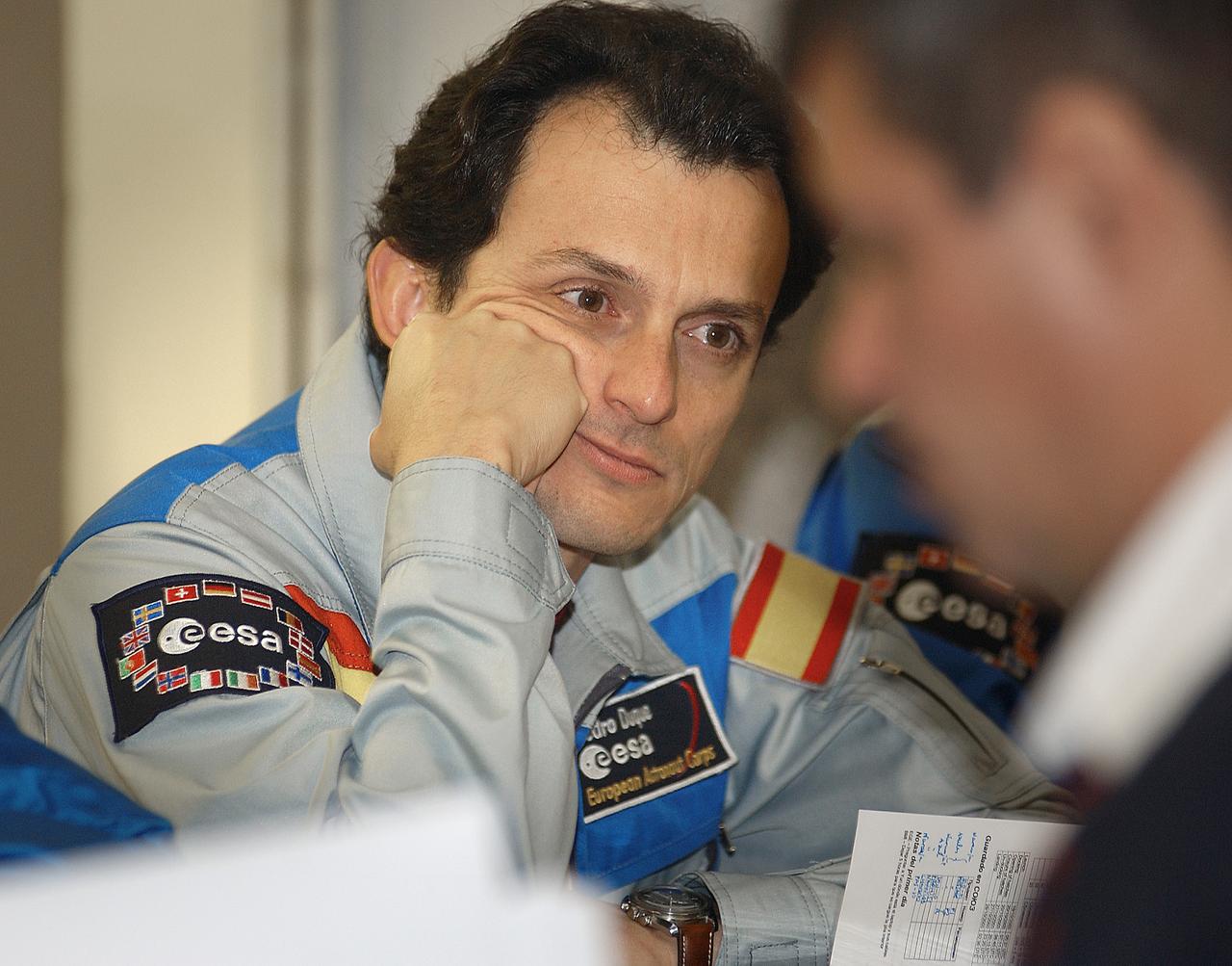 October 15, 2003. Cosmonaut Hotel, Baikonur, Kazakhstan. European Space Agency Astronaut Pedro Duque of Spain listens to a briefing on mission activities from a Russian trainer at his crew quarters in Baikonur, Kazakhstan Oct. 15, 2003 as he prepares for his launch to the International Space Station Oct. 18 in a Soyuz TMA-3 vehicle. Duque will be joined by Expedition 8 Commander Mike Foale and Expedition 8 Soyuz Commander Alexander Kaleri. Photo Credit: "NASA/Bill Ingalls"