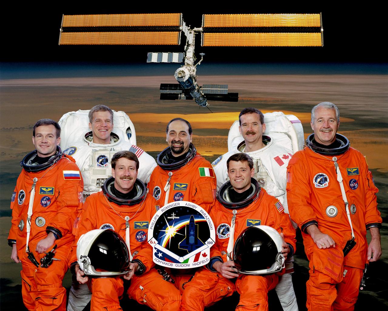 This is the official crew portrait of the STS-100 mission. Seated are astronauts Kent V. Rominger, (left) and Jeffrey S. Ashby, commander and pilot, respectively. Standing (from the left) are cosmonaut Yuri V. Lonchakov with astronauts Scott E. Parazynski, Umberto Guidoni of the European Space Agency, Chris A. Hadfield, and John L. Phillips, all mission specialists. The seven launched from the Kennedy Space Center aboard the Space shuttle Orbiter Endeavour on April 19, 2001 for an 11-day mission. The STS-100 mission, the sixth International Space Station (ISS) assembly flight, accomplished the following objectives: The delivery of the Canadian-built Space Station Remote Manipulator System (SSRMS), Canadarm2, which is needed to perform assembly operations on later flights; The delivery and installation of a UHF antenna that provides space-to-space communications capability for U.S.-based space walks; and carried the Italian-built Multipurpose Logistics Module Raffaello containing six system racks and two storage racks for the U.S. Lab, Destiny.