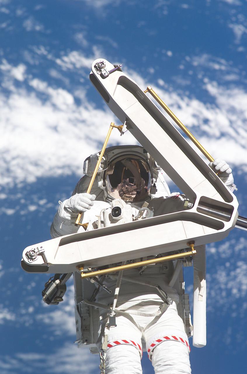 Hovering in space some 240 miles above the blue and white Earth, STS-110 astronaut M.E. Morin participates in his first ever and second of four scheduled space walks for the STS-110 mission. He is seen toting one of the S0 (S-Zero) keel pins which were removed from their functional position on the truss and attached on the truss' exterior for long term stowage. The 43-foot-long, 27,000 pound S0 truss was the first of 9 segments that will make up the International Space Station's external framework that will eventually stretch 356 feet (109 meters), or approximately the length of a football field. This central truss segment also includes a flatcar called the Mobile Transporter and rails that will become the first "space railroad," which will allow the Station's robotic arm to travel up and down the finished truss for future assembly and maintenance. The completed truss structure will hold solar arrays and radiators to provide power and cooling for additional international research laboratories from Japan and Europe that will be attached to the Station. The mission completed the installations and preparations of the S0 truss and the Mobile Transporter within four space walks. STS-110 Extravehicular Activity (EVA) marked the first use of the Station's robotic arm to maneuver space walkers around the Station and was the first time all of a shuttle crew's space walks were based out of the Station's Quest Airlock. It was also the first Shuttle to use three Block II Main Engines. The Space Shuttle Orbiter Atlantis STS-110 mission was launched April 8, 2002 and returned to Earth April 19, 2002.
