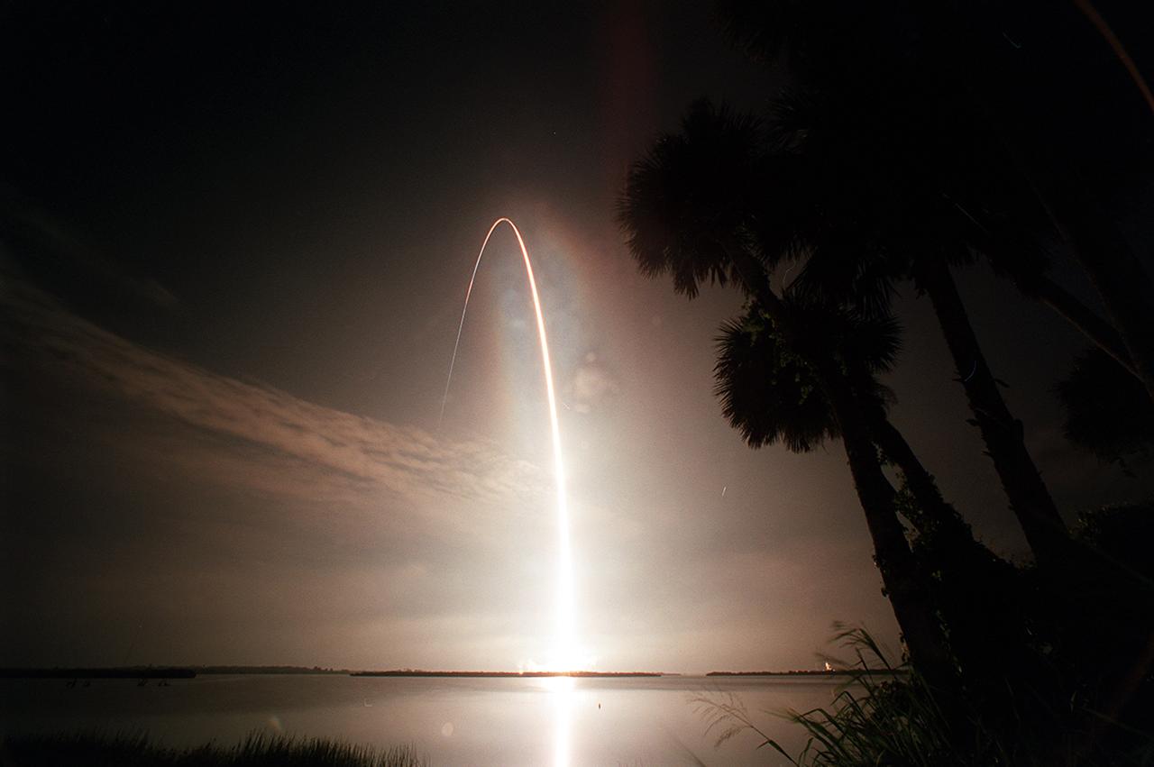 The Space Shuttle Atlantis arcs into the black sky over the Atlantic Ocean casting a fiery glow on its way. Atlantis STS-104 launched from Kennedy Launch Pad 39B at 5:03:59 am EDT, headed for the International Space Station (ISS). Its crew of five served as the 10th ISS assembly flight. The primary payload of the mission was the Joint Airlock module which was attached in two space walks. Once installed and activated, the ISS Airlock became the primary path for ISS space walk entry and departure for U.S. space suits, which are known as Extravehicular Mobility Units (EMUs). In addition, it is designed to support the Russian Orlan space suit. The Joint Airlock is 20-feet long, 13- feet in diameter and weighs 6.5 tons. The airlock includes two sections, the larger equipment lock on the left that will store space suits and associated gear, and the narrower crew lock on the right from which astronauts will exit into space for extravehicular activity. It was built at the Marshall Space Flight Center (MSFC) by the Space Station prime contractor Boeing.
