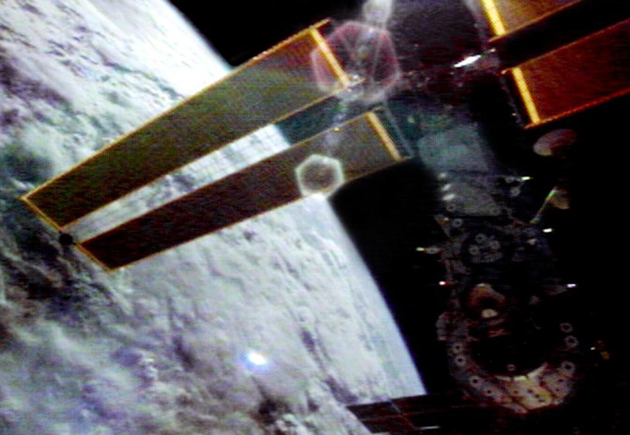This video still depicts the recently deployed starboard and port solar arrays towering over the International Space Station (ISS). The video was recorded on STS-97's 65th orbit. Delivery, assembly, and activation of the solar arrays was the main mission objective of STS-97. The electrical power system, which is built into a 73-meter (240-foot) long solar array structure consists of solar arrays, radiators, batteries, and electronics, and will provide the power necessary for the first ISS crews to live and work in the U.S. segment. The entire 15.4-metric ton (17-ton) package is called the P6 Integrated Truss Segment, and is the heaviest and largest element yet delivered to the station aboard a space shuttle. The STS-97 crew of five launched aboard the Space Shuttle Orbiter Endeavor on November 30, 2000 for an 11 day mission.