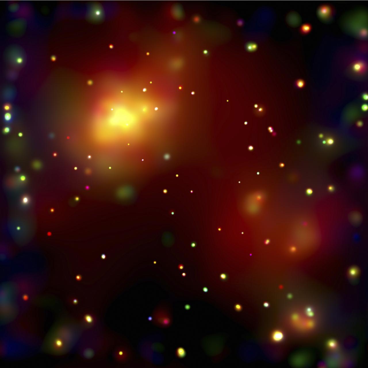 This image of the galaxy cluster Abell 2125, provided by the Chandra X-Ray Observatory (CXO), reveals several massive multimillion degree Celsius gas clouds that appear to be in the process of merging. Ten of the point-like sources are associated with galaxies in the cluster and the rest are probably distant background galaxies. The small bright feature in the extreme lower right-hand corner is probably a background galaxy cluster not associated with Abell 2125. The bright gas cloud on the upper left is the core of the cluster and envelopes hundreds of galaxies. It consists of several elongated clouds that are merging. Chandra, Hubble Space Telescope (HST), and Very Large Array radio telescope data show that several galaxies in the Abell 2125 core cluster are being stripped of their gas as they fall through surrounding high-pressure hot gas. This stripping process has enriched the core cluster's gas in heavy elements such as iron. In contrast, the bright large cloud on the lower right envelopes hundreds of galaxies and has an extraordinarily low concentration of iron atoms. It is thought that this cloud, which is several million light years from the core cluster, has not yet been enriched by the stripping of iron-rich gas from its member galaxies. Over time, as this cloud merges into the core and the hot gas pressure increases, iron atoms should be swept from the galaxies. Building a massive galaxy cluster is a step-by-step enterprise that takes billions of years and affects the growth and evolution of the member galaxies. The observations of A 2125 provide a rare glimpse into the early steps in this process. NASA’s Marshall Space Flight Center in Huntsville, Alabama manages both the Chandra and Hubble programs.  (NASA/UMass/D. Wang et al.))