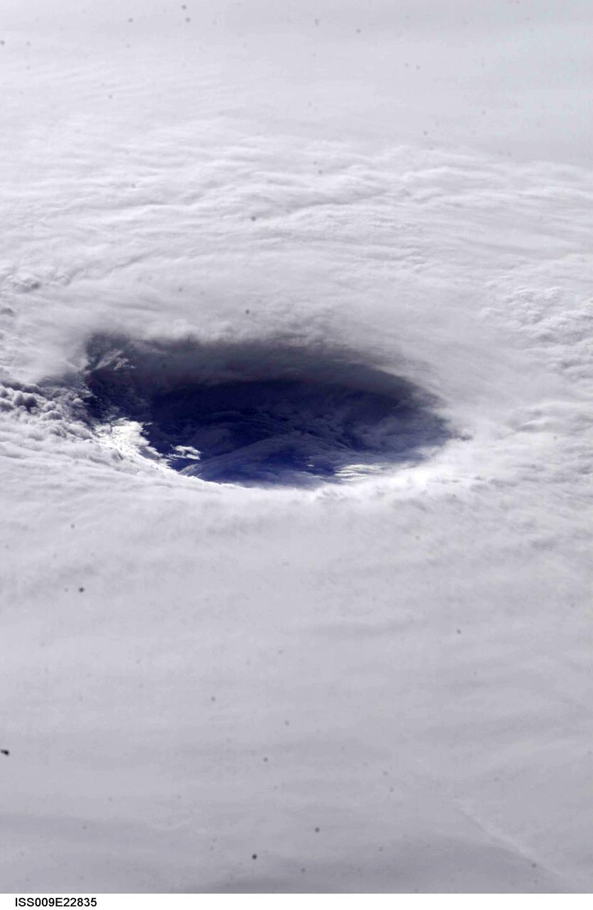 This image hosts a look into the eye of Hurricane Ivan, one of the strongest hurricanes on record, as the storm approached landfall on the central Gulf coast Wednesday afternoon on September 15, 2004. The hurricane was photographed by astronaut Edward M. (Mike) Fincke from aboard the International Space Station (ISS) at an altitude of approximately 230 miles. At the time, sustained winds in the eye of the wall were reported at about 135 mph as the downgraded category 4 storm approached the Alabama coast. Crew Earth Observations record Earth surface changes over time, as well as more fleeting events such as storms, floods, fires, and volcanic eruptions.