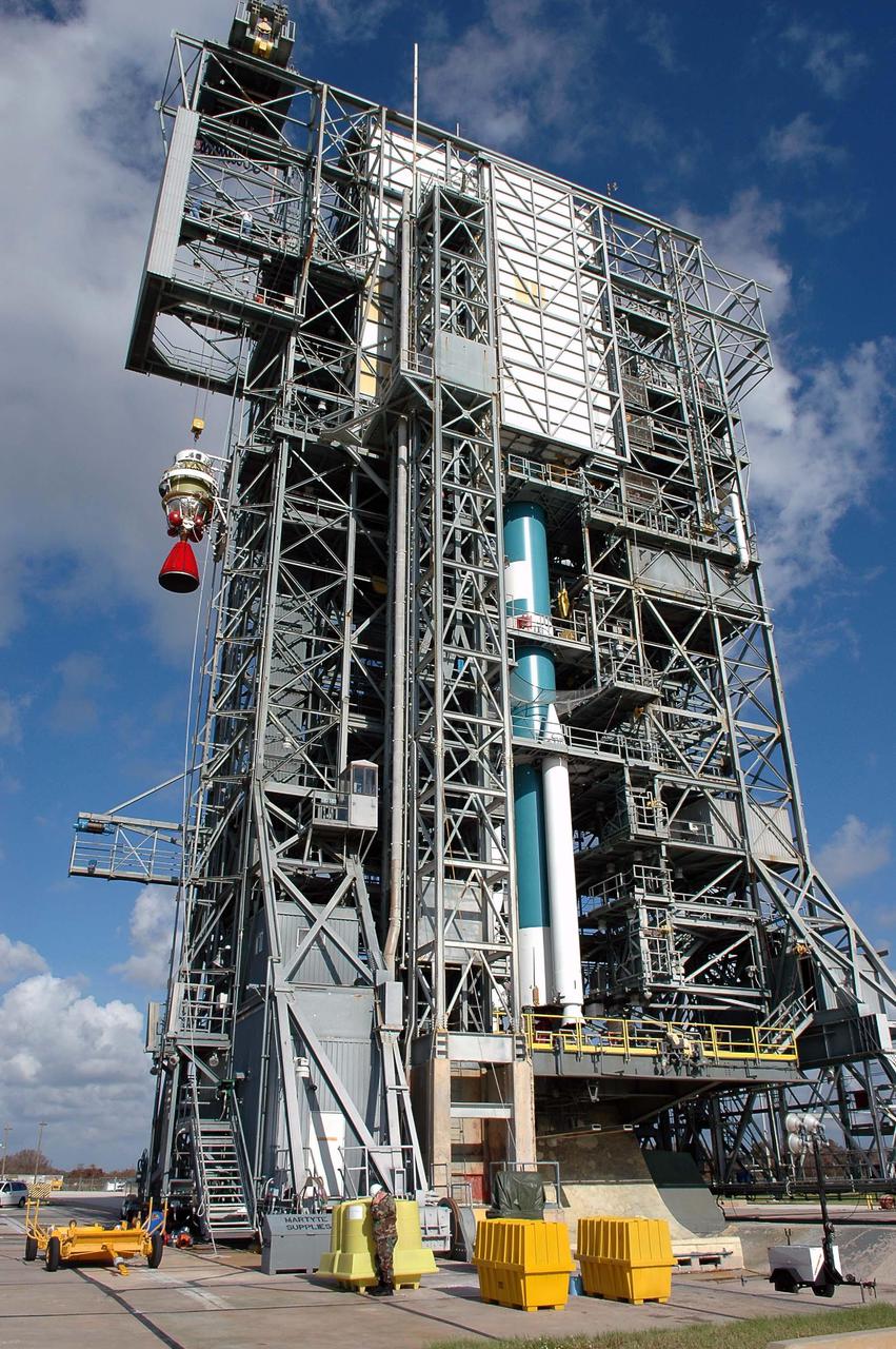 KENNEDY SPACE CENTER, FLA. - At Launch Pad 17-A on Cape Canaveral Air Force Station, the second stage of the Boeing Delta II launch vehicle (at left) is being lifted up the mobile service tower for mating with the first stage (seen at right). The rocket is the launch vehicle for the Swift spacecraft and its Gamma-Ray Burst Mission, now scheduled for liftoff Nov. 8. Swift is a medium-class Explorer mission managed by NASA’s Goddard Space Flight Center in Greenbelt, Md. It is a first-of-its-kind multi-wavelength observatory dedicated to the study of gamma-ray burst (GRB) science. Its three instruments will work together to observe GRBs and afterglows in the gamma ray, X-ray, ultraviolet and optical wavebands. KSC is responsible for Swift’s integration with the Boeing Delta II rocket and the countdown management on launch day.