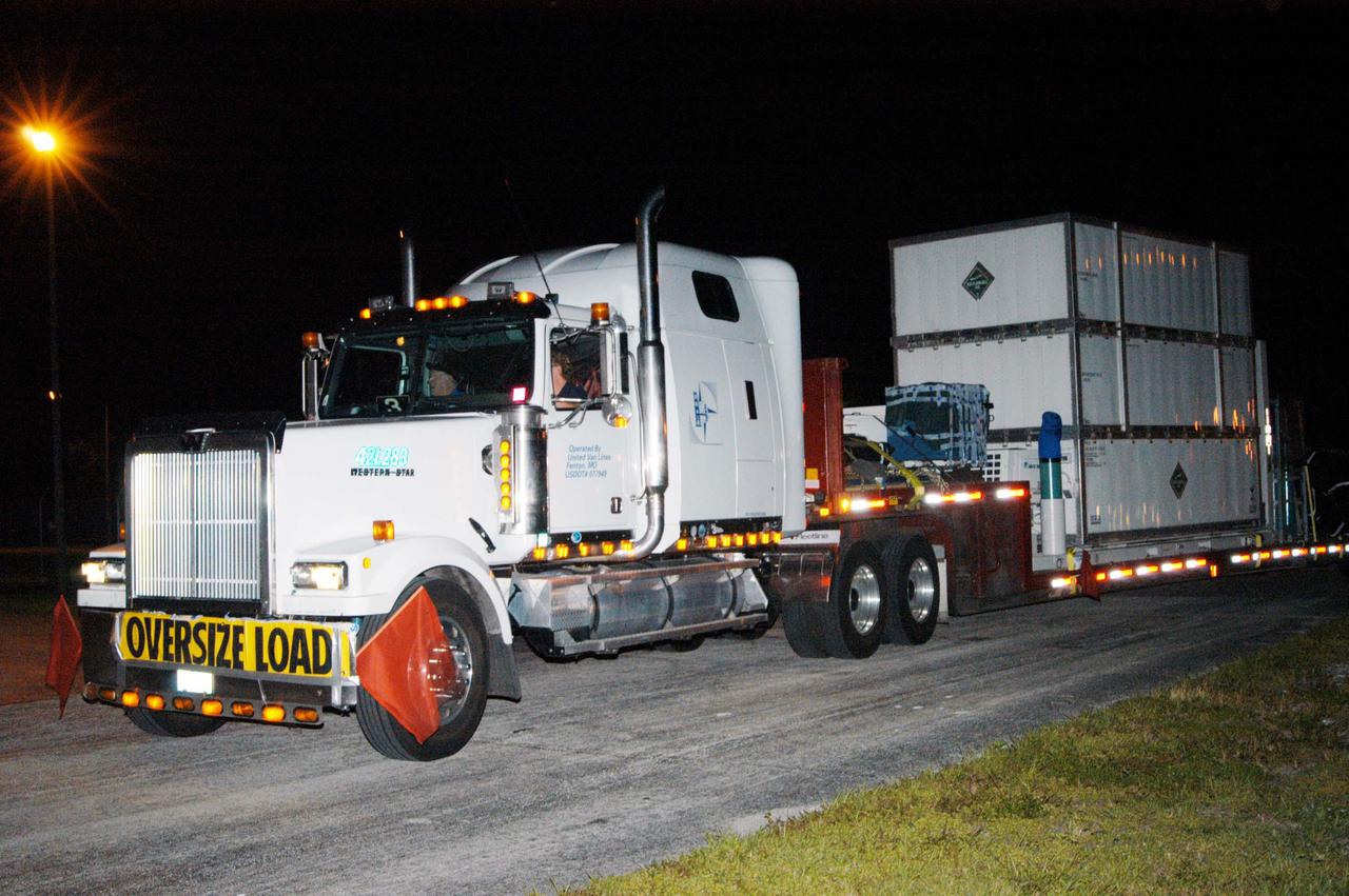 KENNEDY SPACE CENTER, FLA. - The NASA Discovery Mission Deep Impact spacecraft arrives via truck from Ball Aerospace and Technologies Corp. in Boulder, Colo. It is being taken to Astrotech Space Operations near Kennedy Space Center. Deep Impact is designed to launch a copper projectile into the surface of Comet Tempel 1 on July 4, 2005, when the comet is 83 million miles from Earth. When this 820-pound “impactor” hits the surface of the comet at nearly 23,000 miles per hour, the 3- by 3-foot projectile will create a crater hundreds of feet in size. Deep Impact’s flyby spacecraft will collect pictures and data of how the crater forms, measuring the crater’s depth and diameter, as well as the composition of the interior of the crater and any material thrown out, and determining the changes in natural outgassing produced by the impact. It will send the data back to Earth through the antennas of the Deep Space Network. The spacecraft is scheduled to launch Dec. 30, 2004, aboard a Boeing Delta II rocket from Launch Complex 17 at Cape Canaveral Air Force Station, Fla.