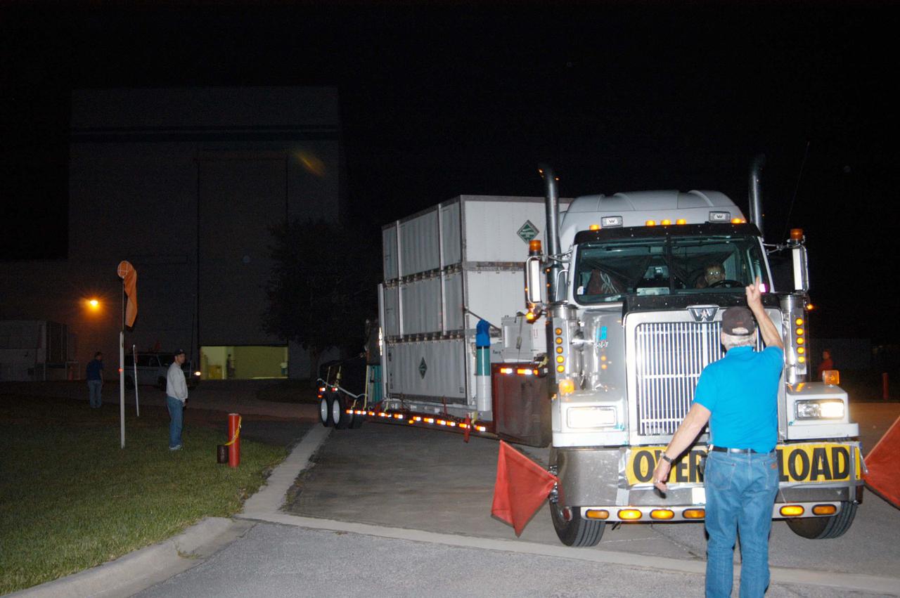 KENNEDY SPACE CENTER, FLA. - The truck carrying the NASA Discovery Mission Deep Impact spacecraft arrives from Ball Aerospace and Technologies Corp. in Boulder, Colo. It is being taken to Astrotech Space Operations near Kennedy Space Center. Deep Impact is designed to launch a copper projectile into the surface of Comet Tempel 1 on July 4, 2005, when the comet is 83 million miles from Earth. When this 820-pound “impactor” hits the surface of the comet at nearly 23,000 miles per hour, the 3- by 3-foot projectile will create a crater hundreds of feet in size. Deep Impact’s flyby spacecraft will collect pictures and data of how the crater forms, measuring the crater’s depth and diameter, as well as the composition of the interior of the crater and any material thrown out, and determining the changes in natural outgassing produced by the impact. It will send the data back to Earth through the antennas of the Deep Space Network. The spacecraft is scheduled to launch Dec. 30, 2004, aboard a Boeing Delta II rocket from Launch Complex 17 at Cape Canaveral Air Force Station, Fla.