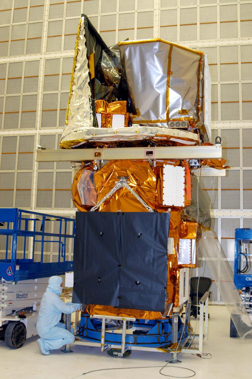 KENNEDY SPACE CENTER, FLA. - A technician at NASA’s Hangar AE, Cape Canaveral Air Force Station (CCAFS), prepares the Swift spacecraft to be lifted off its workstand. The spacecraft will be mated to a payload attach fitting, the interface between the spacecraft and the second stage of the Boeing Delta II rocket. Swift is a first-of-its-kind multi-wavelength observatory dedicated to the study of gamma-ray burst (GRB) science. Its three instruments will work together to observe GRBs and afterglows in the gamma ray, X-ray, ultraviolet and optical wavebands. Swift is expected to observe more than 200 gamma-ray bursts - the most comprehensive study of GRB afterglows to date - during its 2-year mission. Swift is scheduled to launch in November from Launch Pad 17-A at CCAFS.