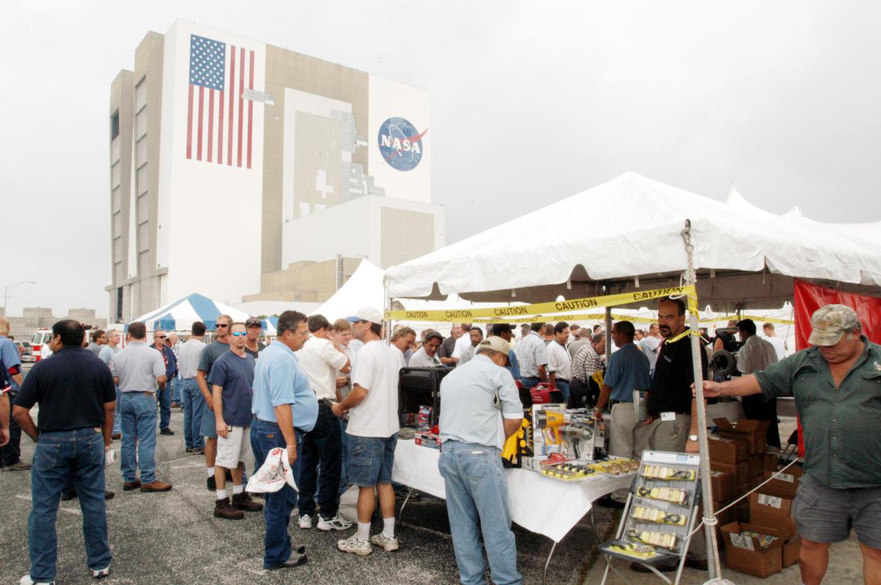 KENNEDY SPACE CENTER, FLA. -   Employees at KSC stroll among several tents featuring vendors’ exhibits of safety- and health-related products.  The exhibits were part of Spaceport Super Safety and Health Day, which also featured presentations by guest speakers Dr. Pamela Peeke, Navy Com. Stephen E. Iwanowicz, NASA’s Dr. Kristine Calderon and Olympic-great Bruce Jenner.   Vendors’ exhibits were set up in the parking areas outside the Vehicle Assembly Building (seen here) and the OandC Building. The annual event was initiated at KSC in 1998 to increase awareness of the importance of safety and health among the government and contractor workforce.  The theme for this year’s event was “Safety and Health: A Winning Combination.”