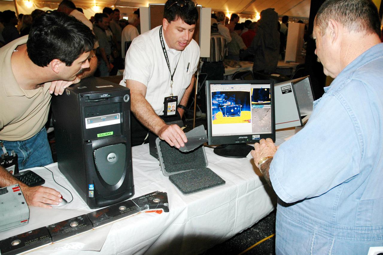 KENNEDY SPACE CENTER, FLA. -   Inside a tent, employees at KSC look over an exhibit of special equipment during Spaceport Super Safety and Health Day. Vendors’ exhibits were set up in the parking areas outside the Vehicle Assembly Building and the OandC Building. The day-long event also featured presentations by guest speakers Dr. Pamela Peeke, Navy Com. Stephen E. Iwanowicz, NASA’s Dr. Kristine Calderon and Olympic-great Bruce Jenner.   Super Safety and Health Day was initiated at KSC in 1998 to increase awareness of the importance of safety and health among the government and contractor workforce.  The theme for this year’s event was “Safety and Health: A Winning Combination.”