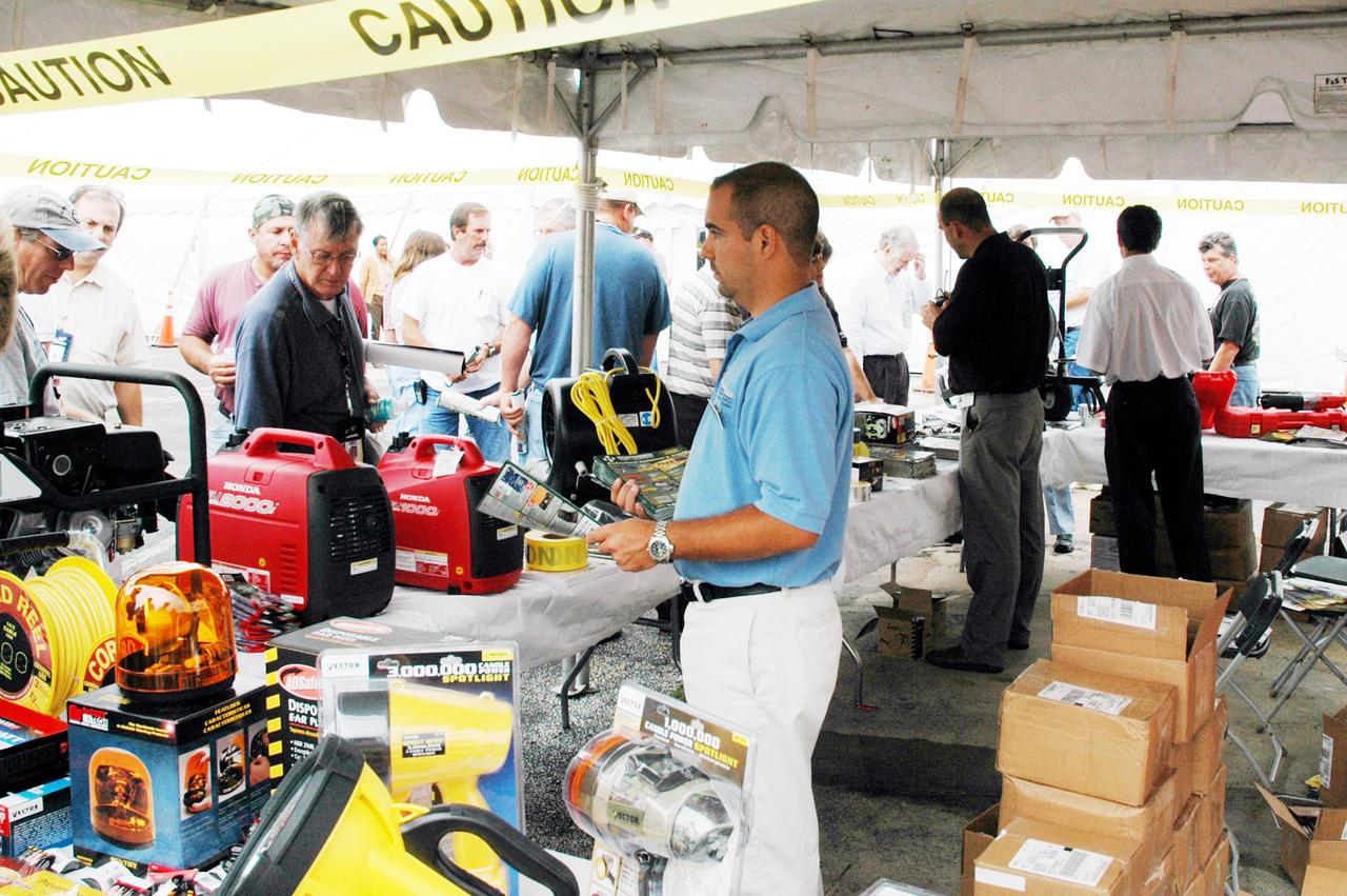 KENNEDY SPACE CENTER, FLA. - Inside a tent, employees at KSC look over an exhibit of safety equipment during Spaceport Super Safety and Health Day. Vendors’ exhibits were set up in the parking areas outside the Vehicle Assembly Building and the OandC Building. The day-long event also featured presentations by guest speakers Dr. Pamela Peeke, Navy Com. Stephen E. Iwanowicz, NASA’s Dr. Kristine Calderon and Olympic-great Bruce Jenner. Super Safety and Health Day was initiated at KSC in 1998 to increase awareness of the importance of safety and health among the government and contractor workforce. The theme for this year’s event was “Safety and Health: A Winning Combination.”