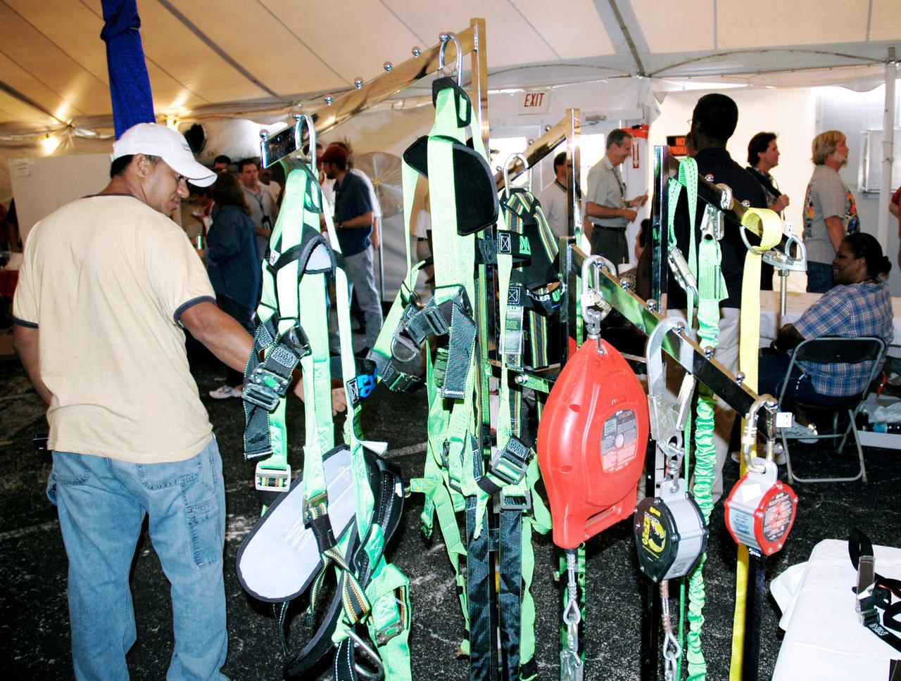 KENNEDY SPACE CENTER, FLA. -  Employees at KSC take time to look at safety equipment on display during Spaceport Super Safety and Health Day. Vendors’ exhibits were set up in the parking areas outside the Vehicle Assembly Building and the OandC Building. The day-long event also featured presentations by guest speakers Dr. Pamela Peeke, Navy Com. Stephen E. Iwanowicz, NASA’s Dr. Kristine Calderon and Olympic-great Bruce Jenner.   Super Safety and Health Day was initiated at KSC in 1998 to increase awareness of the importance of safety and health among the government and contractor workforce.  The theme for this year’s event was “Safety and Health: A Winning Combination.”
