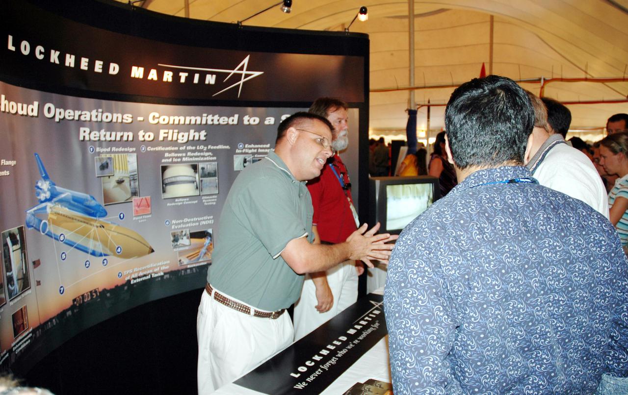 KENNEDY SPACE CENTER, FLA. -  Lockheed Martin representatives explain some of the activities they are working on for safe Return to Flight of the Space Shuttle.  The exhibit was one of many presented to KSC employees during Spaceport Super Safety and Health Day. Vendors’ exhibits were set up in the parking areas outside the Vehicle Assembly Building and the OandC Building. The day-long event also featured presentations by guest speakers Dr. Pamela Peeke, Navy Com. Stephen E. Iwanowicz, NASA’s Dr. Kristine Calderon and Olympic-great Bruce Jenner.   Super Safety and Health Day was initiated at KSC in 1998 to increase awareness of the importance of safety and health among the government and contractor workforce.  The theme for this year’s event was “Safety and Health: A Winning Combination.”