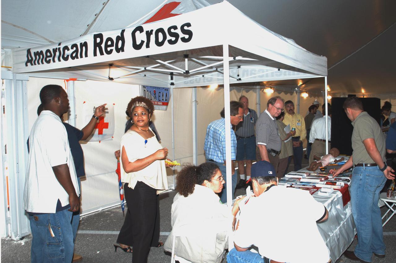 KENNEDY SPACE CENTER, FLA. -  KSC Employees stop by the American Red Cross exhibit during Spaceport Super Safety and Health Day. The event included guest speakers Dr. Pamela Peeke, Navy Com. Stephen E. Iwanowicz, NASA’s Dr. Kristine Calderon and Olympic-great Bruce Jenner.  In addition, many vendors’ exhibits were on display for employees.  Super Safety and Health Day was initiated at KSC in 1998 to increase awareness of the importance of safety and health among the government and contractor workforce.  The theme for this year’s event was “Safety and Health: A Winning Combination.”