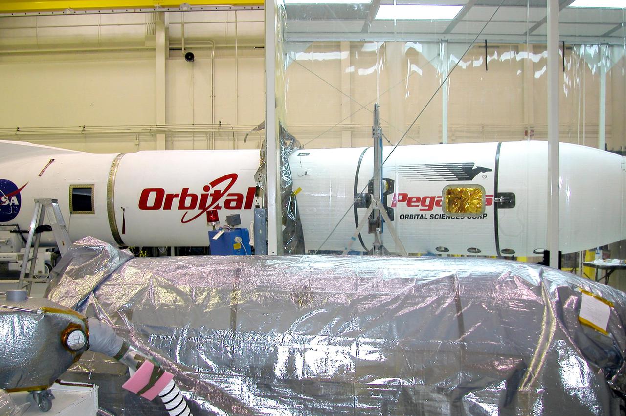 KENNEDY SPACE CENTER, FLA. - At Vandenberg Air Force Base in California, the Demonstration of Autonomous Rendezvous Technology (DART) is encapsulated and ready to be moved to the runway where it will be attached to the Orbital Sciences Corporation Stargazer L-1011 aircraft. DART was designed and built for NASA by Orbital Sciences as an advanced flight demonstrator to locate and maneuver near an orbiting satellite. The DART spacecraft weighs about 800 pounds and is nearly 6 feet long and 3 feet in diameter. From beneath the belly of the Orbital Sciences L-1011 aircraft, the Pegasus XL vehicle will launch DART into a circular polar orbit of approximately 475 miles. The DART satellite provides a key step in establishing autonomous rendezvous capabilities for the U.S. Space Program. While previous rendezvous and docking efforts have been piloted by astronauts, the unmanned DART satellite will have computers and cameras to perform its rendezvous functions.