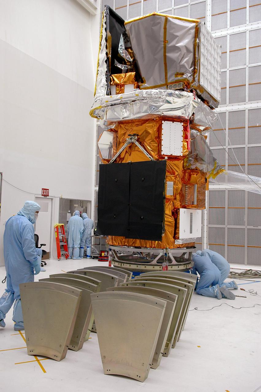 KENNEDY SPACE CENTER, FLA. - At NASA’s Hangar AE on Cape Canaveral Air Force Station (CCAFS), Fla., preparations are underway to enclose the Swift spacecraft in a canister before moving it to the launch pad. The base petals are lined up around the work stand before attaching them to the payload attach fitting on the Swift spacecraft. Swift is a first-of-its-kind multi-wavelength observatory dedicated to the study of gamma-ray burst (GRB) science. Its three instruments will work together to observe GRBs and afterglows in the gamma ray, X-ray, ultraviolet and optical wavebands. Swift is expected to observe more than 200 gamma-ray bursts - the most comprehensive study of GRB afterglows to date - during its 2-year mission. Swift is scheduled to launch in mid-November from Launch Pad 17-A at CCAFS.