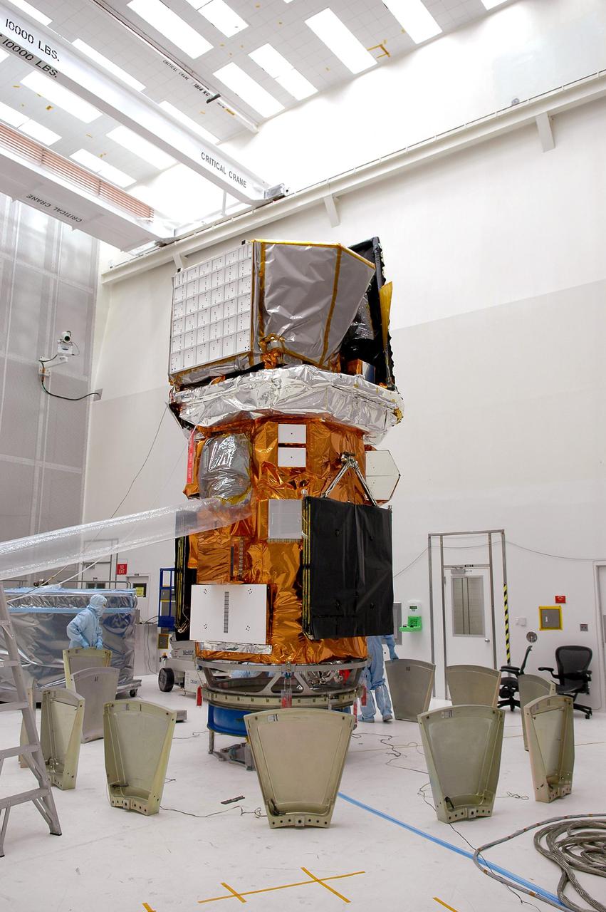 KENNEDY SPACE CENTER, FLA. - At NASA’s Hangar AE on Cape Canaveral Air Force Station (CCAFS), Fla., preparations are underway to enclose the Swift spacecraft in a canister before moving it to the launch pad. The base petals are lined up around the work stand before attaching them to the payload attach fitting on the Swift spacecraft. Swift is a first-of-its-kind multi-wavelength observatory dedicated to the study of gamma-ray burst (GRB) science. Its three instruments will work together to observe GRBs and afterglows in the gamma ray, X-ray, ultraviolet and optical wavebands. Swift is expected to observe more than 200 gamma-ray bursts - the most comprehensive study of GRB afterglows to date - during its 2-year mission. Swift is scheduled to launch in mid-November from Launch Pad 17-A at CCAFS.