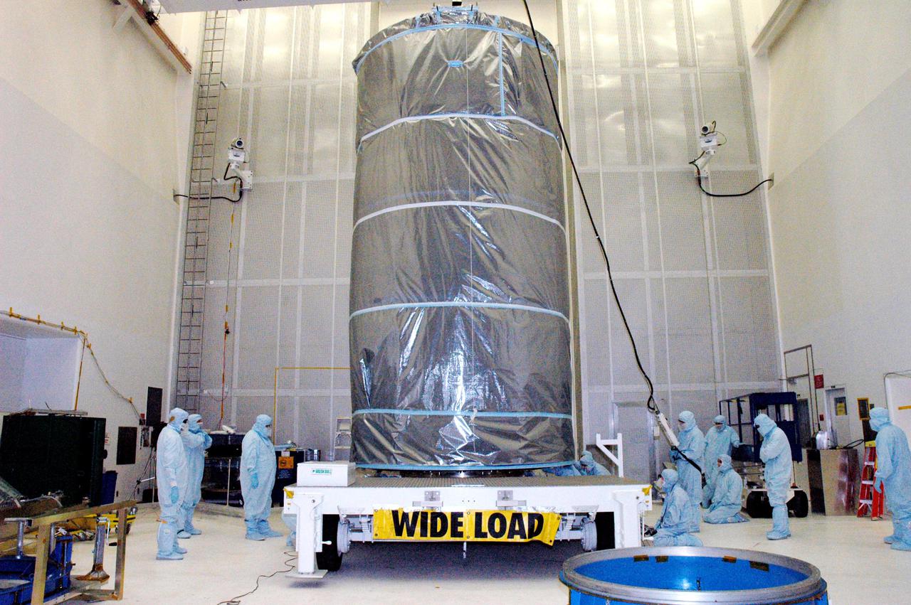 KENNEDY SPACE CENTER, FLA. -  The Swift spacecraft, fully encased inside the payload transfer canister, is secured on a transport vehicle for a trip to the launch pad. The launch of the Swift observatory, a NASA spacecraft to pinpoint the location of gamma-ray bursts, is scheduled for Nov. 17 from Pad 17-A on CCAFS. Liftoff aboard a Boeing Delta II rocket is targeted at the opening of a one-hour launch window beginning at 12:09 p.m. EST.  Gamma-ray bursts are distant, yet fleeting explosions that appear to signal the births of black holes.  They are the most powerful explosions known in the universe, emitting more than 100 billion times the energy that the Sun emits in a year.  Yet they last only from a few milliseconds to a few minutes, never to appear in the same spot again.