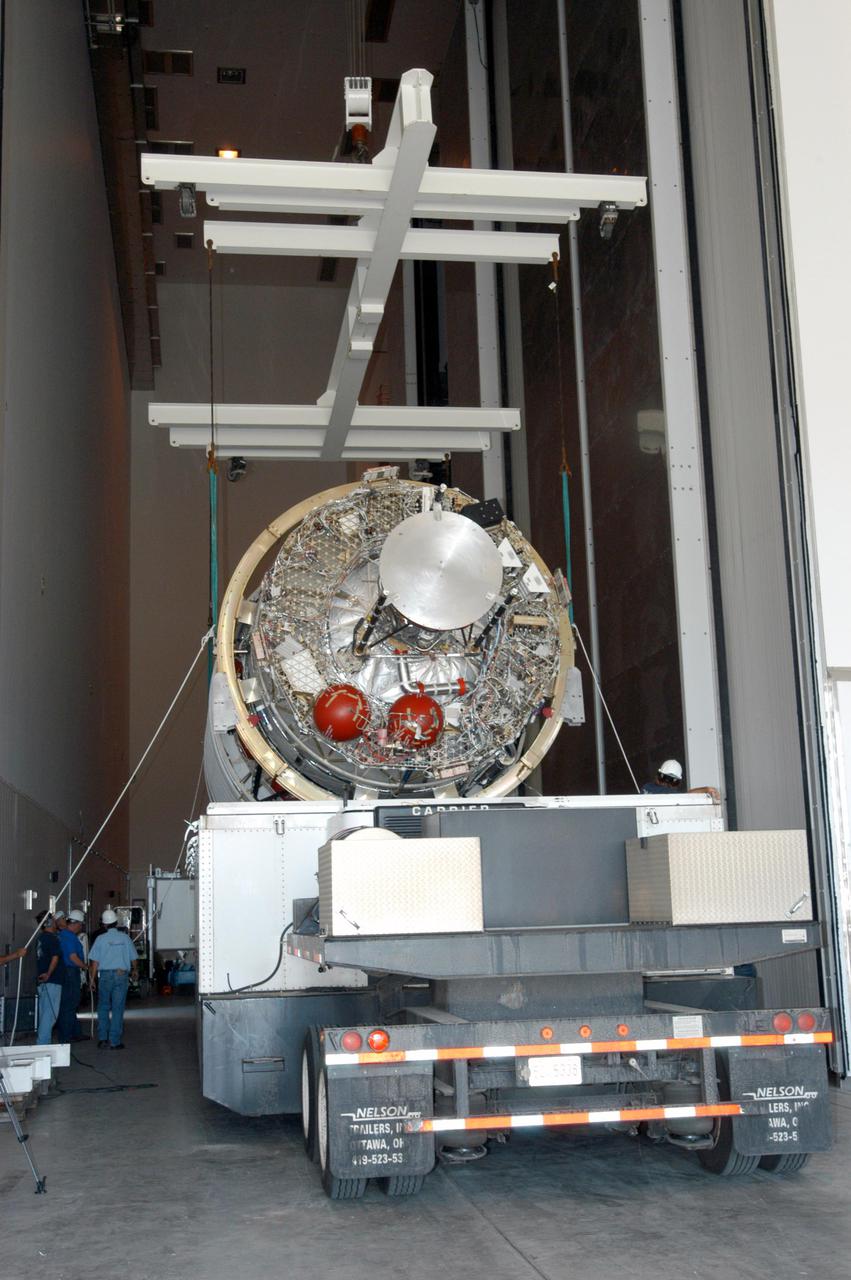 KENNEDY SPACE CENTER, FLA. - At the Boeing Delta Operations Center, the Boeing Delta IV second stage is rolled inside. The Delta IV rocket will be used for the 2005 launching of the GOES-N weather satellite for NASA and NOAA (National Oceanic and Atmospheric Administration). The first in a series of three advanced weather satellites including GOES-O and GOES-P, the GOES-N will provide continuous monitoring necessary for intensive data analysis. It will provide a constant vigil for the atmospheric “triggers” of severe weather conditions such as tornadoes, flash floods, hail storms and hurricanes. When these conditions develop, GOES-N will be able to monitor storm development and track their movements.