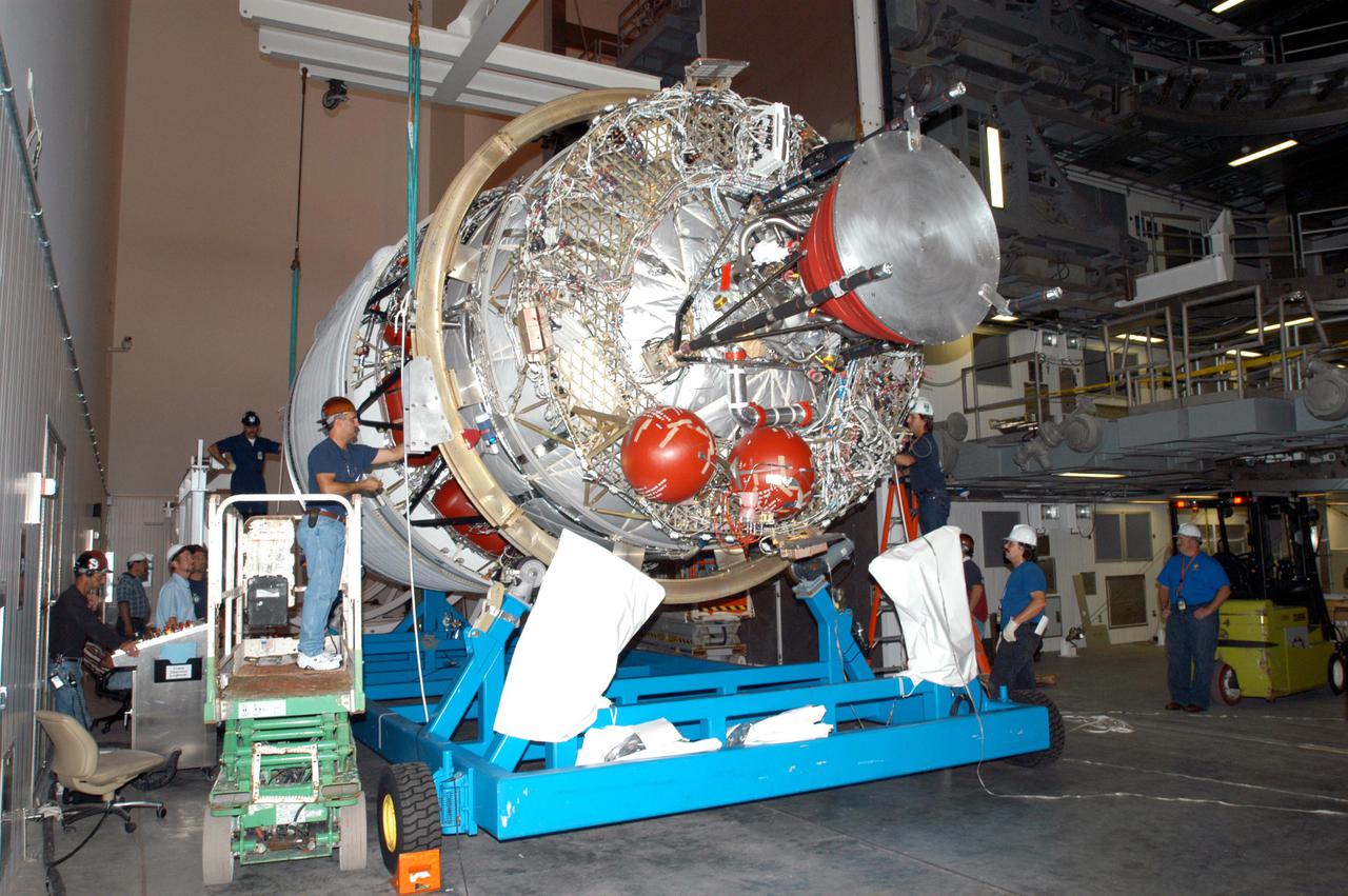 KENNEDY SPACE CENTER, FLA. - At the Boeing Delta Operations Center, workers prepare the second stage of a Boeing Delta IV launch vehicle for transfer from its transporter to a work stand. The Delta IV rocket will be used for the 2005 launching of the GOES-N weather satellite for NASA and NOAA (National Oceanic and Atmospheric Administration). The first in a series of three advanced weather satellites including GOES-O and GOES-P, the GOES-N will provide continuous monitoring necessary for intensive data analysis. It will provide a constant vigil for the atmospheric “triggers” of severe weather conditions such as tornadoes, flash floods, hail storms and hurricanes. When these conditions develop, GOES-N will be able to monitor storm development and track their movements.