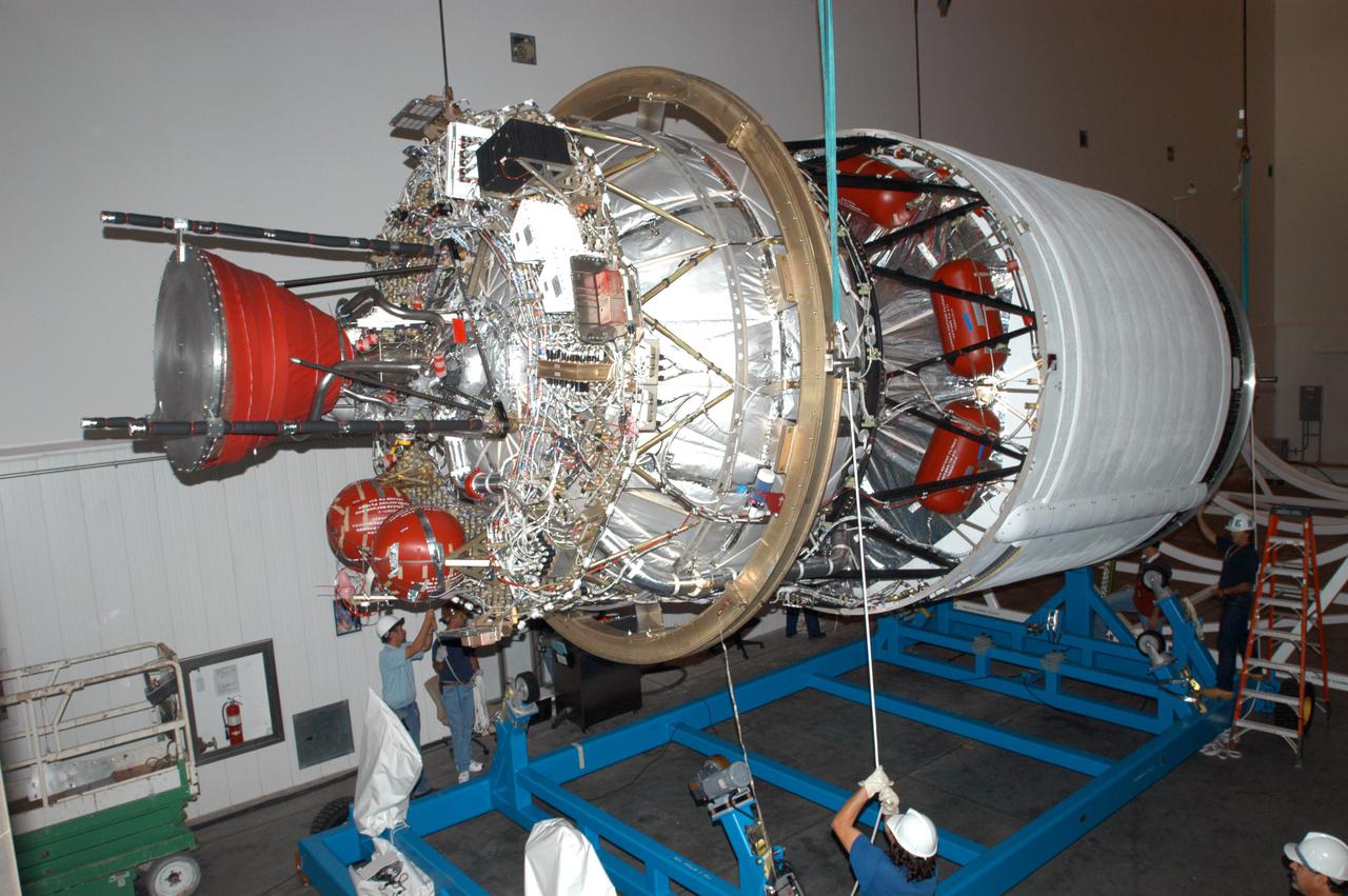 KENNEDY SPACE CENTER, FLA. - At the Boeing Delta Operations Center, the second stage of a Boeing Delta IV launch vehicle is lifted off its transporter for transfer to a work stand. The Delta IV rocket will be used for the 2005 launching of the GOES-N weather satellite for NASA and NOAA (National Oceanic and Atmospheric Administration). The first in a series of three advanced weather satellites including GOES-O and GOES-P, the GOES-N will provide continuous monitoring necessary for intensive data analysis. It will provide a constant vigil for the atmospheric “triggers” of severe weather conditions such as tornadoes, flash floods, hail storms and hurricanes. When these conditions develop, GOES-N will be able to monitor storm development and track their movements.