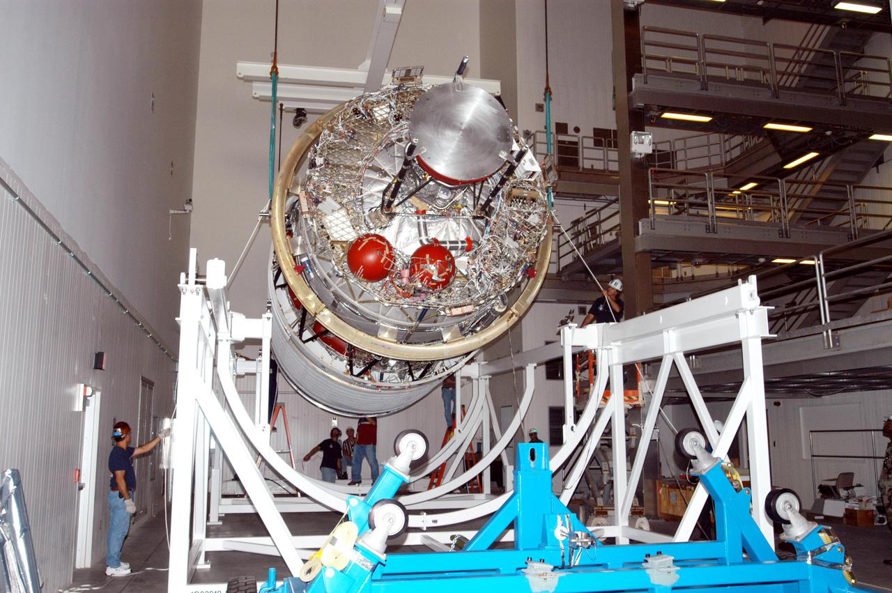 KENNEDY SPACE CENTER, FLA. - In the Boeing Delta Operations Center, the second stage of a Boeing Delta IV launch vehicle is lowered onto a work stand. The Delta IV rocket will be used for the 2005 launching of the GOES-N weather satellite for NASA and NOAA (National Oceanic and Atmospheric Administration). The first in a series of three advanced weather satellites including GOES-O and GOES-P, the GOES-N will provide continuous monitoring necessary for intensive data analysis. It will provide a constant vigil for the atmospheric “triggers” of severe weather conditions such as tornadoes, flash floods, hail storms and hurricanes. When these conditions develop, GOES-N will be able to monitor storm development and track their movements.