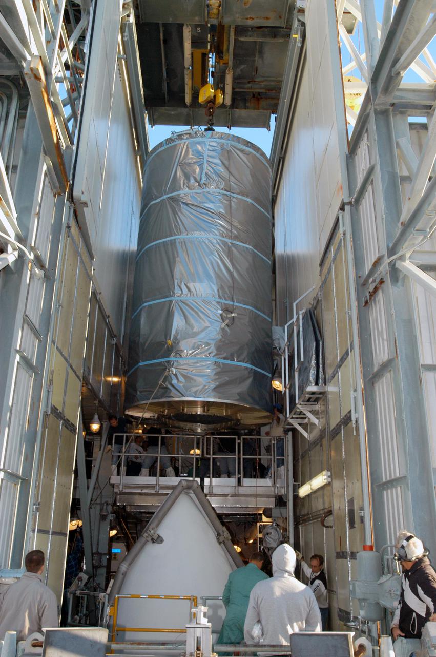 KENNEDY SPACE CENTER, FLA. - In the mobile service tower on Launch Pad 17-A, Cape Canaveral Air Force Station, the Swift spacecraft (above) is moved into position to be lowered onto the Boeing Delta II launch vehicle for mating. Swift is scheduled to launch Nov. 17. The liftoff aboard a Boeing Delta II rocket is targeted at the opening of a one-hour launch window beginning at 12:09 p.m. EST. A first-of-its-kind multi-wavelength observatory dedicated to the study of gamma-ray burst (GRB) science, Swift’s three instruments will work together to observe GRBs and afterglows in the gamma ray, X-ray, ultraviolet and optical wavebands. Gamma-ray bursts are distant, yet fleeting explosions that appear to signal the births of black holes.