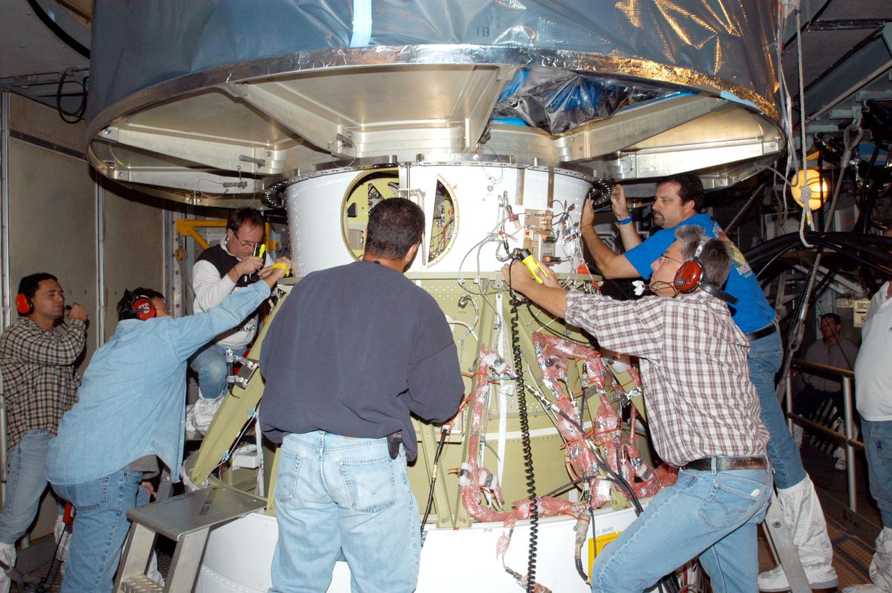 KENNEDY SPACE CENTER, FLA. - In the mobile service tower on Launch Pad 17-A, Cape Canaveral Air Force Station, Boeing technicians attach the Swift spacecraft (above) to the Boeing Delta II second stage. Swift is scheduled to launch Nov. 17. The liftoff aboard a Boeing Delta II rocket is targeted at the opening of a one-hour launch window beginning at 12:09 p.m. EST. A first-of-its-kind multi-wavelength observatory dedicated to the study of gamma-ray burst (GRB) science, Swift’s three instruments will work together to observe GRBs and afterglows in the gamma ray, X-ray, ultraviolet and optical wavebands. Gamma-ray bursts are distant, yet fleeting explosions that appear to signal the births of black holes.
