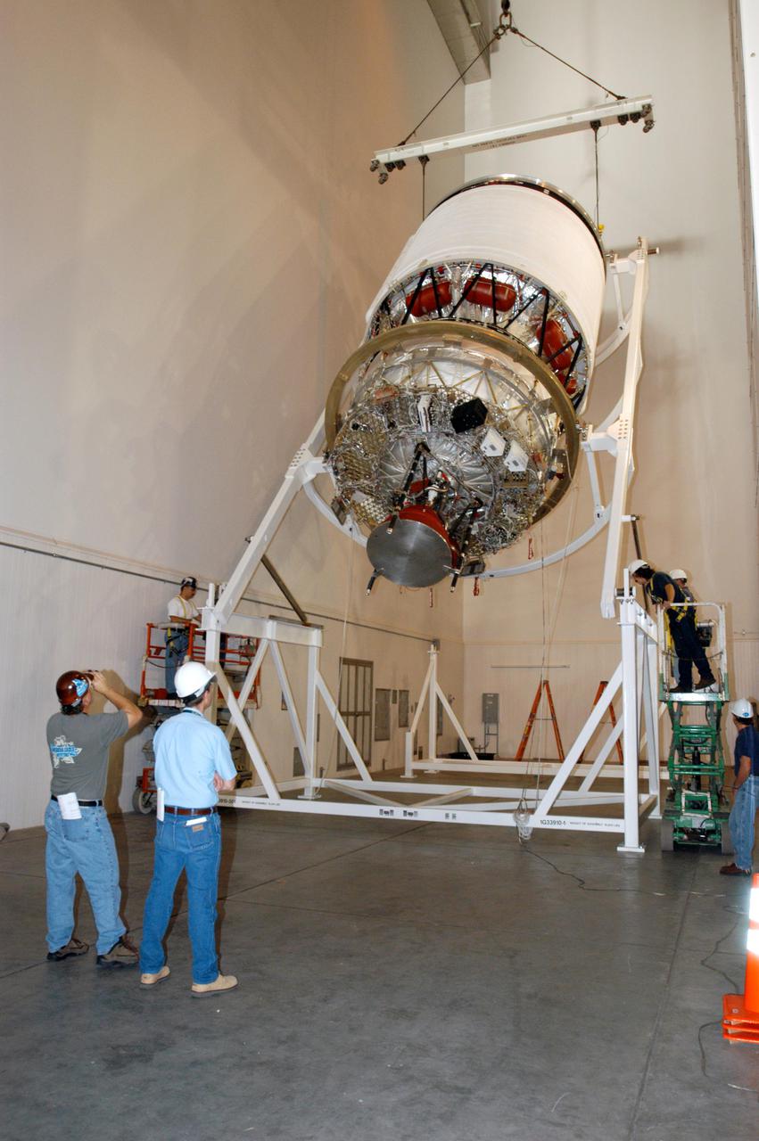 KENNEDY SPACE CENTER, FLA. - At the Boeing Delta Operations Center, the Delta IV second stage is rotated to a vertical position so that the nozzles can be installed. A deployment test will follow. The Delta IV rocket will be used for the 2005 launching of the GOES-N weather satellite for NASA and NOAA (National Oceanic and Atmospheric Administration). The first in a series of three advanced weather satellites including GOES-O and GOES-P, the GOES-N will provide continuous monitoring necessary for intensive data analysis. It will provide a constant vigil for the atmospheric “triggers” of severe weather conditions such as tornadoes, flash floods, hail storms and hurricanes. When these conditions develop, GOES-N will be able to monitor storm development and track their movements.