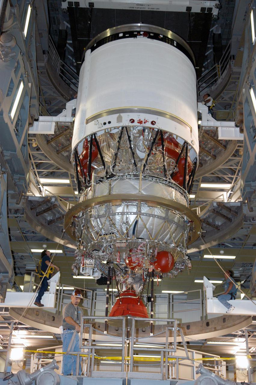 KENNEDY SPACE CENTER, FLA. - At the Boeing Delta Operations Center, the Delta IV second stage is lowered onto a test stand. Nozzles will be installed and a deployment test will follow. The Delta IV rocket will be used for the 2005 launching of the GOES-N weather satellite for NASA and NOAA (National Oceanic and Atmospheric Administration). The first in a series of three advanced weather satellites including GOES-O and GOES-P, the GOES-N will provide continuous monitoring necessary for intensive data analysis. It will provide a constant vigil for the atmospheric “triggers” of severe weather conditions such as tornadoes, flash floods, hail storms and hurricanes. When these conditions develop, GOES-N will be able to monitor storm development and track their movements.