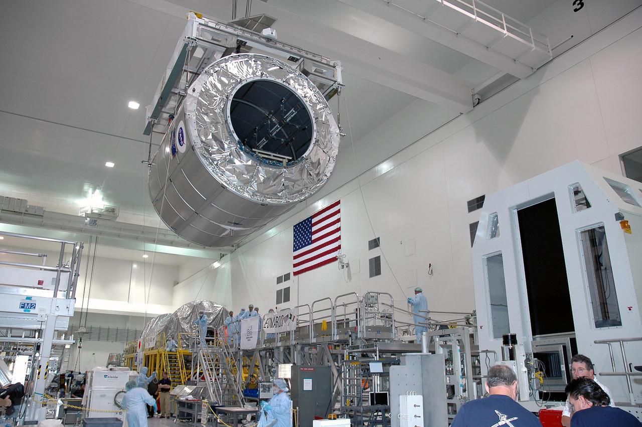 KENNEDY SPACE CENTER, FLA. - Raffaello, the MPLM scheduled to fly on the STS-114 Return to Flight mission, is being moved from a cargo element work stand to an element rotation stand. The latter allows the module to be rotated around its x-axis to facilitate better access to the MPLM during final pre-flight processing operations. STS-114 is a logistics flight (LF1) that will carry the External Stowage Platform plus supplies and equipment to the International Space Station. The planning window for launch is May 12 to June 3, 2005.